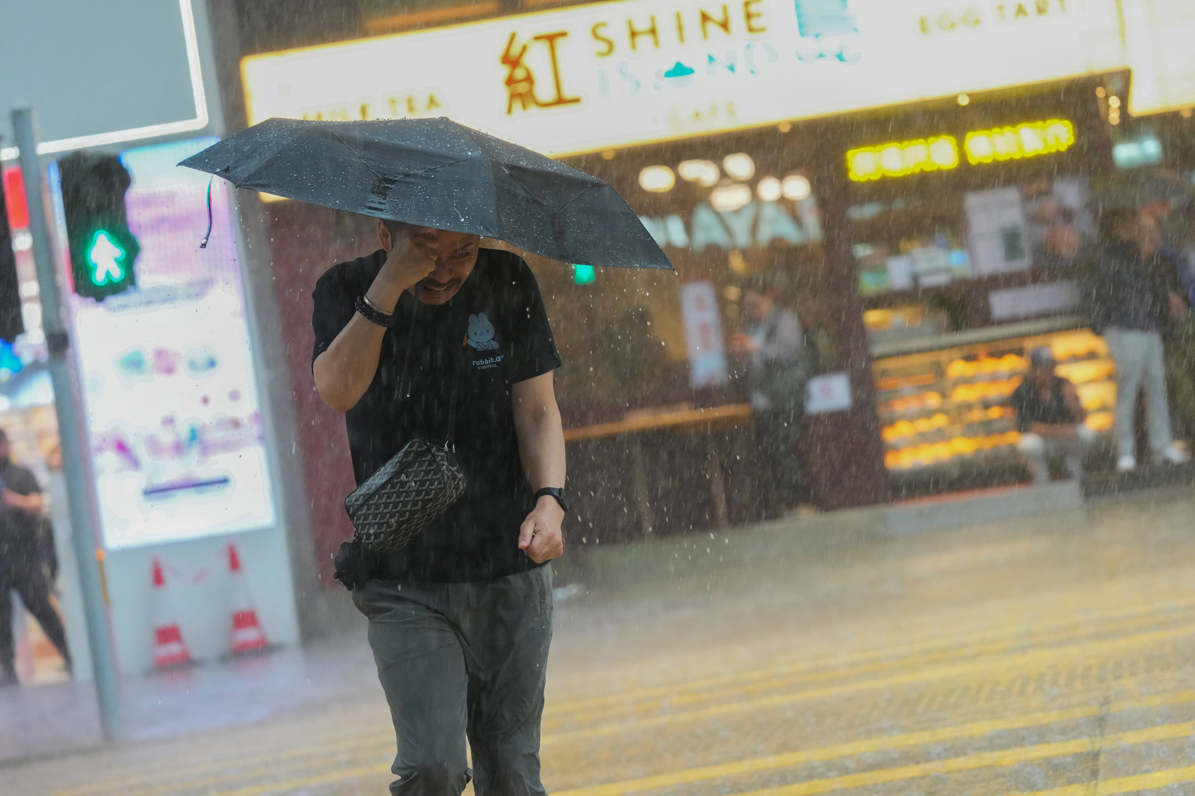 A pedestrian braves the rain in Jordan on Friday. Photo: Jelly Tse