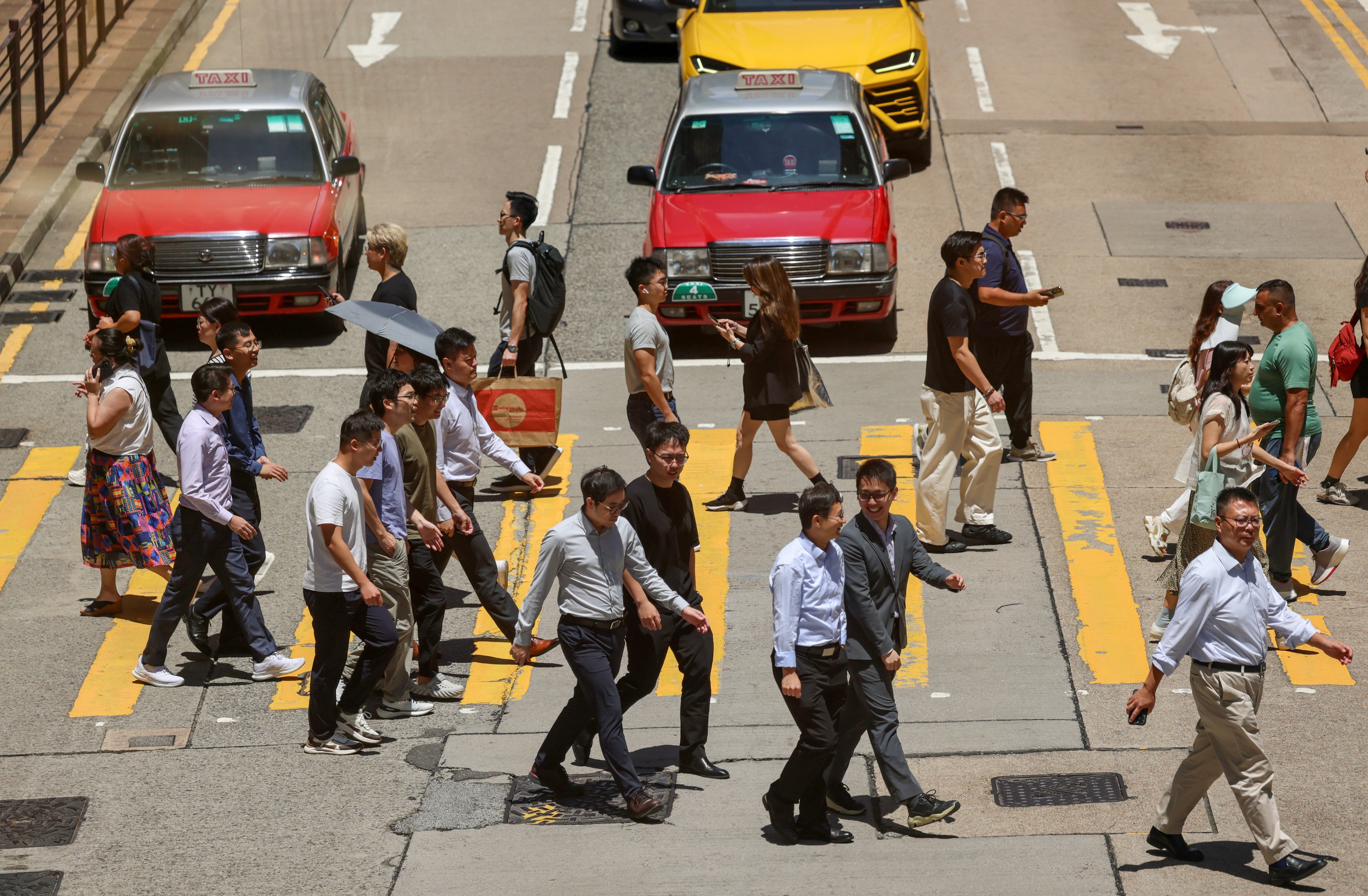 Pedestrians cross a road in Tsim Sha Tsui on August 26 2025. Photo: Jelly Tse