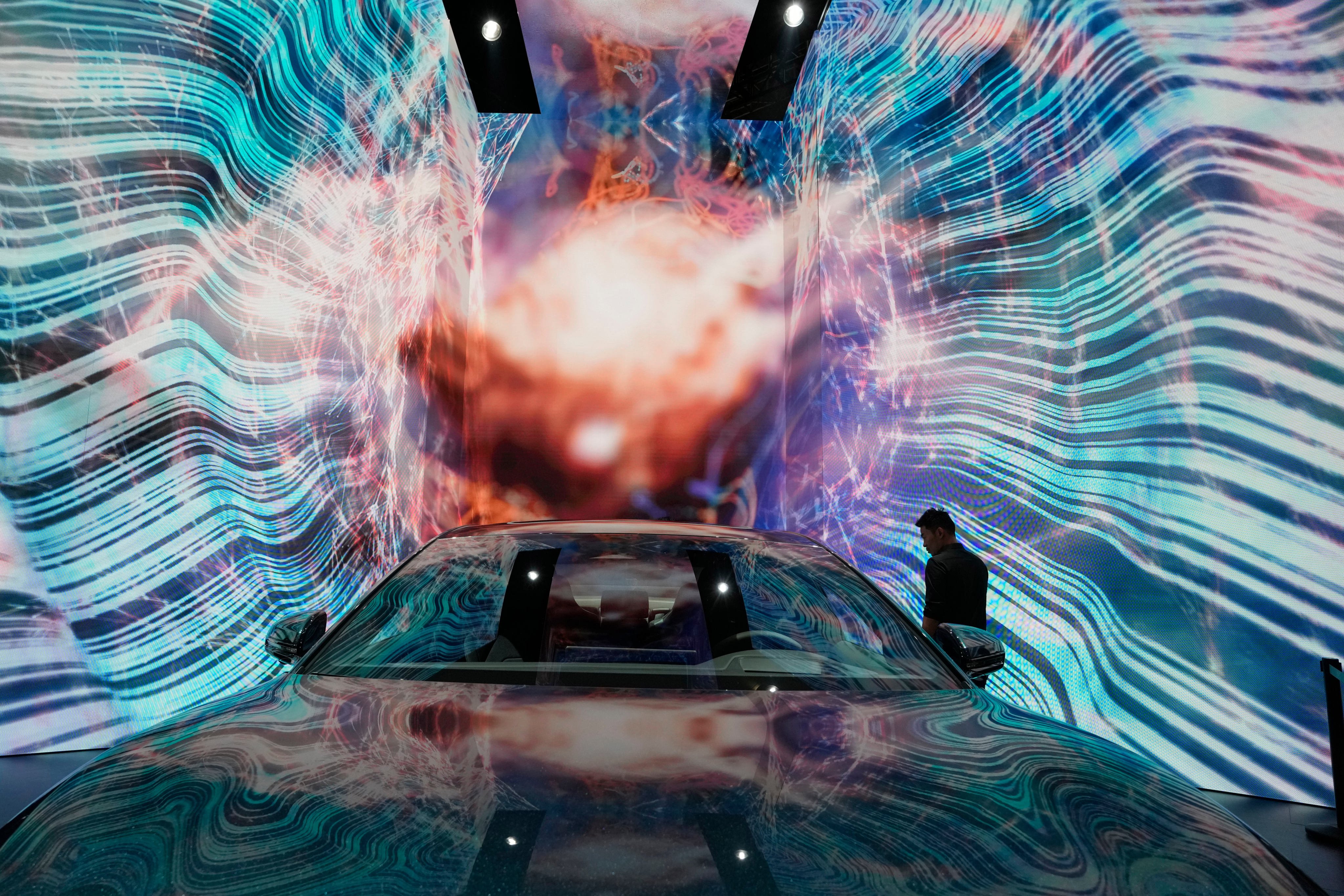 A man looks at an EV from a Chinese carmaker at an auto expo in Shanghai. Photo: AP