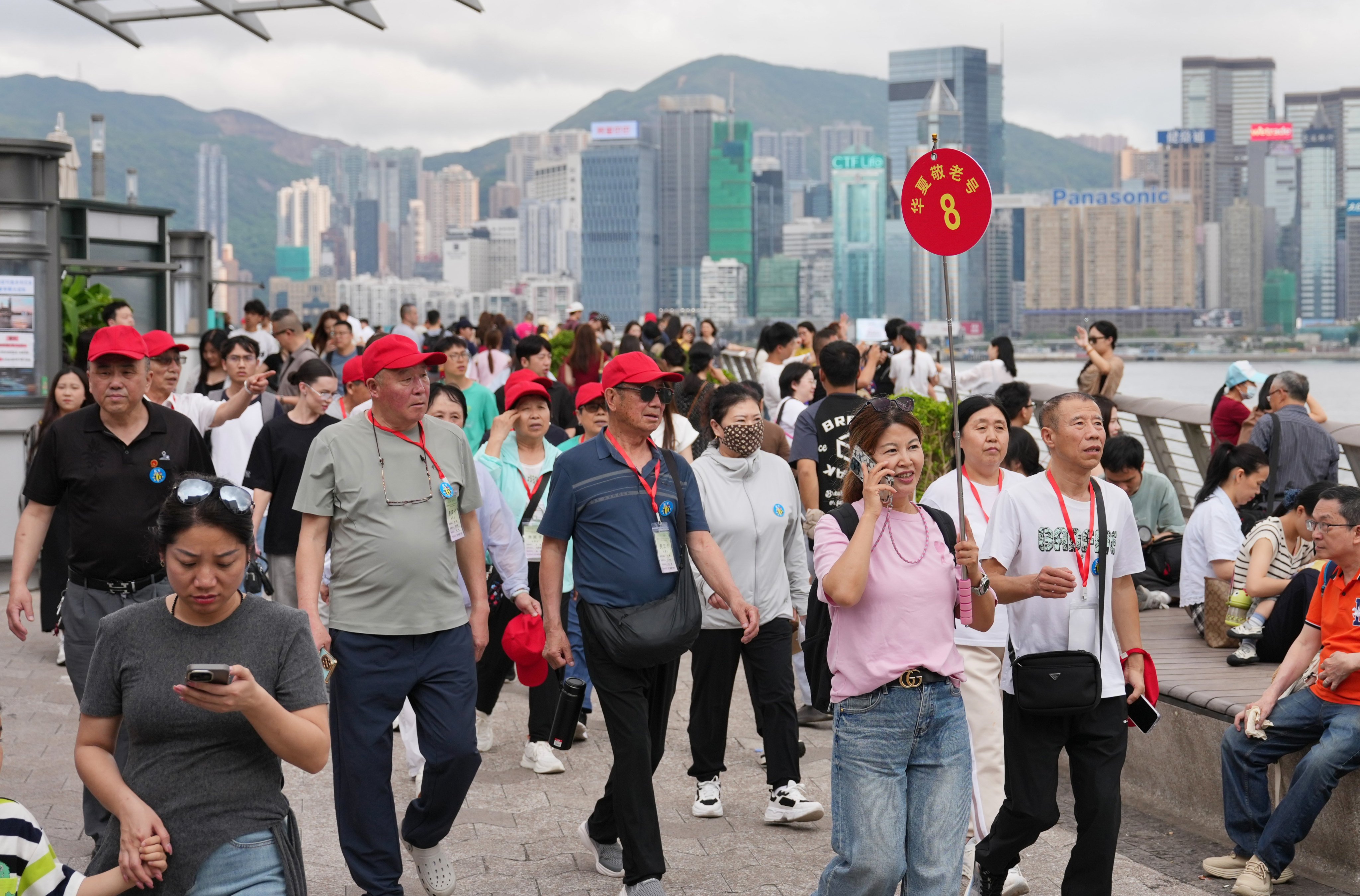 Mainland Chinese visitors and tour groups take photos and stroll along the waterfront in Tsim Sha Tsui on April 14. Photo: Karma Lo