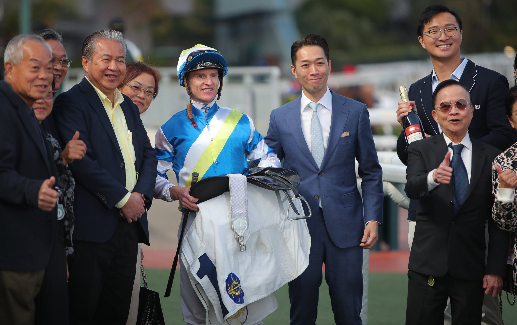 Jockey Zac Purton with connections of Patch Of Cosmo after his win in January.