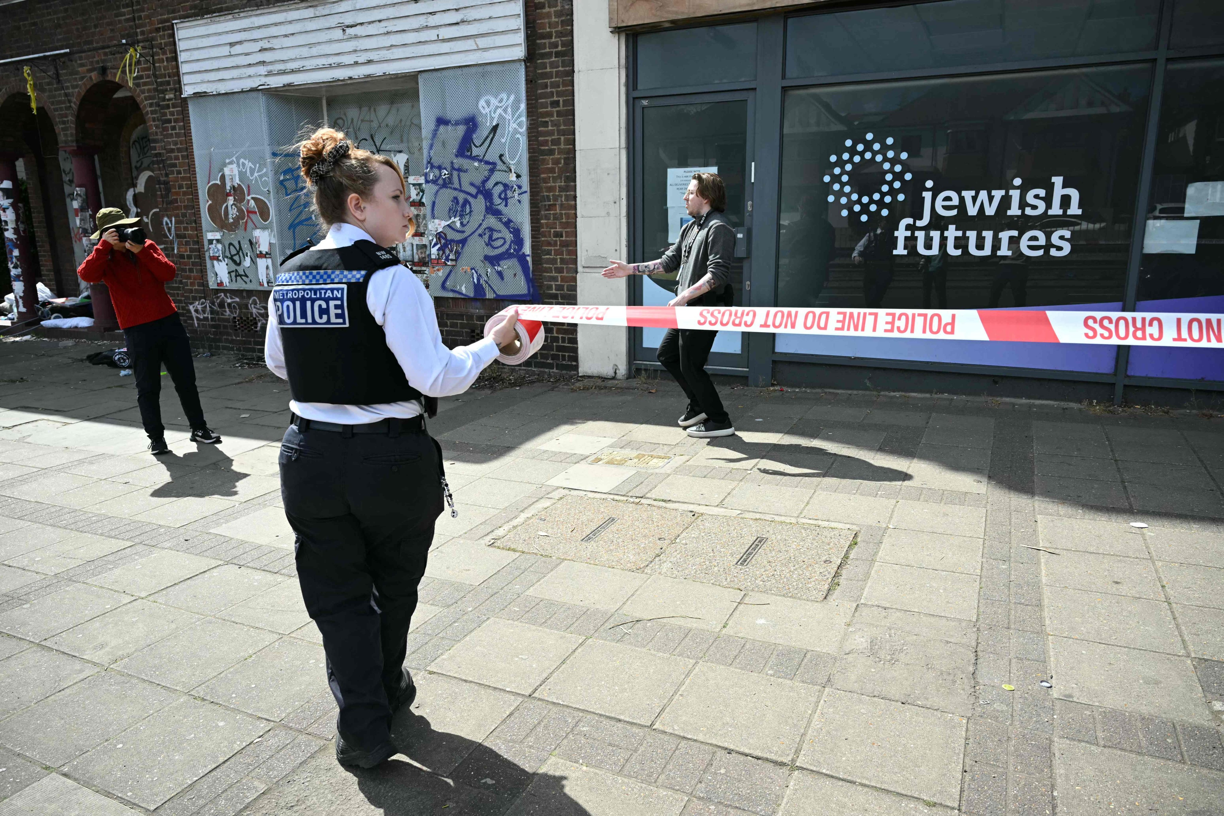 Police on Saturday cordon off the area outside of the business following an arson attack in Hendon, north London. Photo: AFP