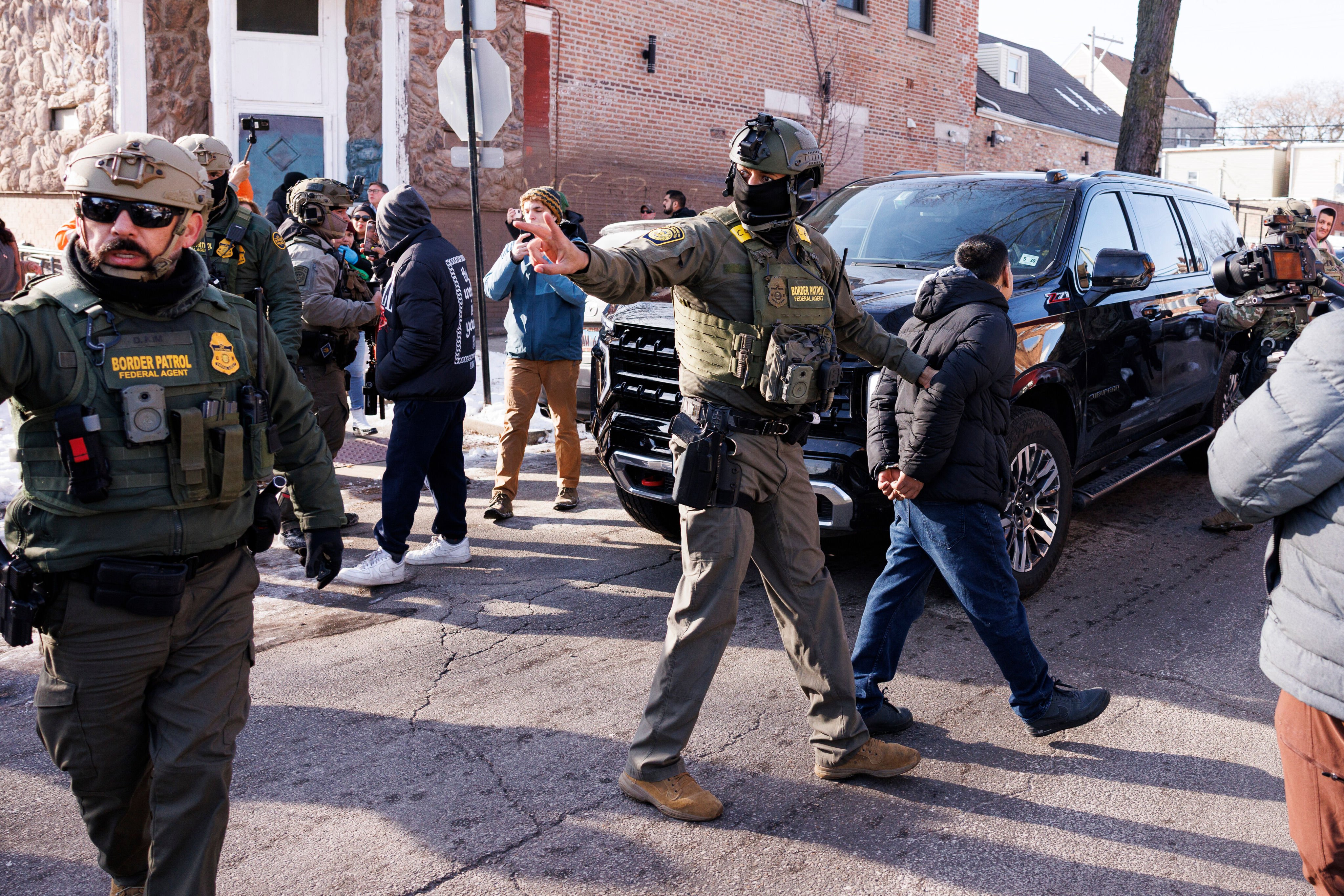 ICE agents detain a man in the Little Village neighbourhood of Chicago on December 16, 2025. Photo: Chicago Sun-Times/AP