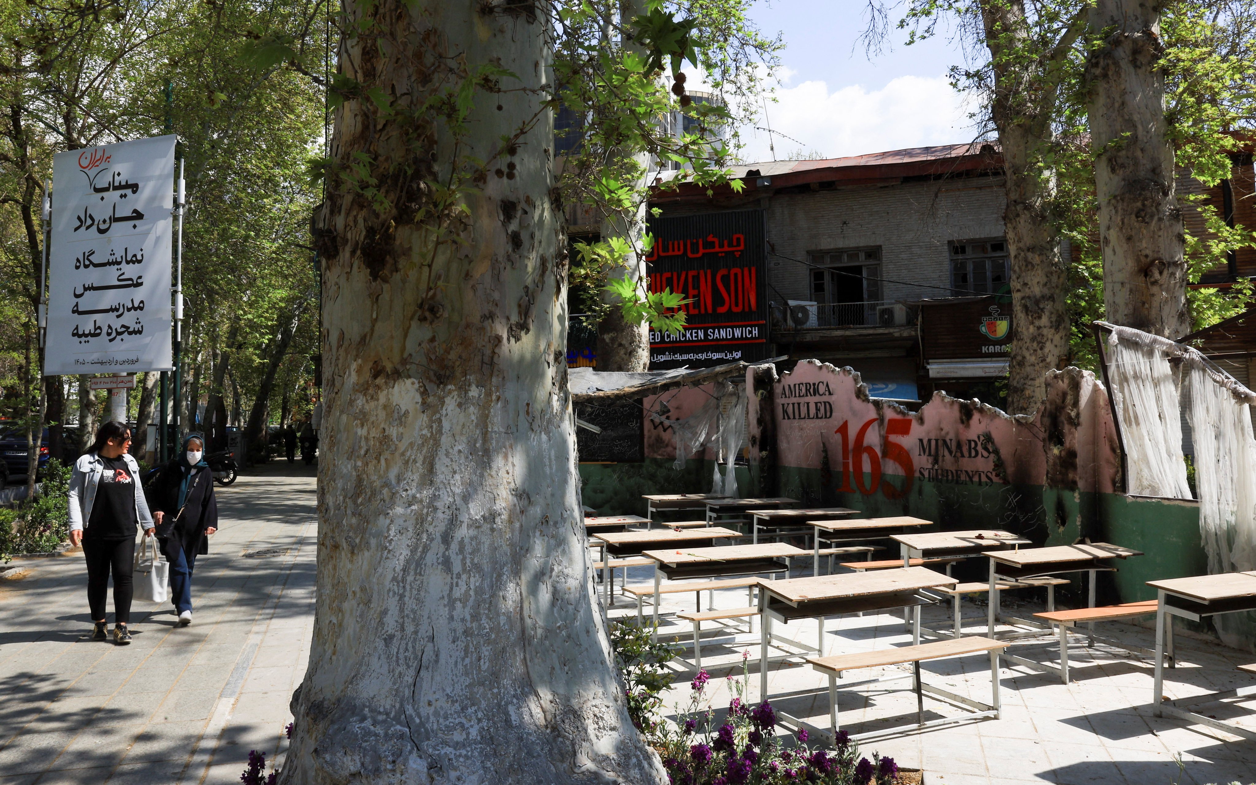 Iranian women walk past a monument for students killed in a February 28 strike on a girls’ primary school in Minab on Wednesday. Photo: Reuters