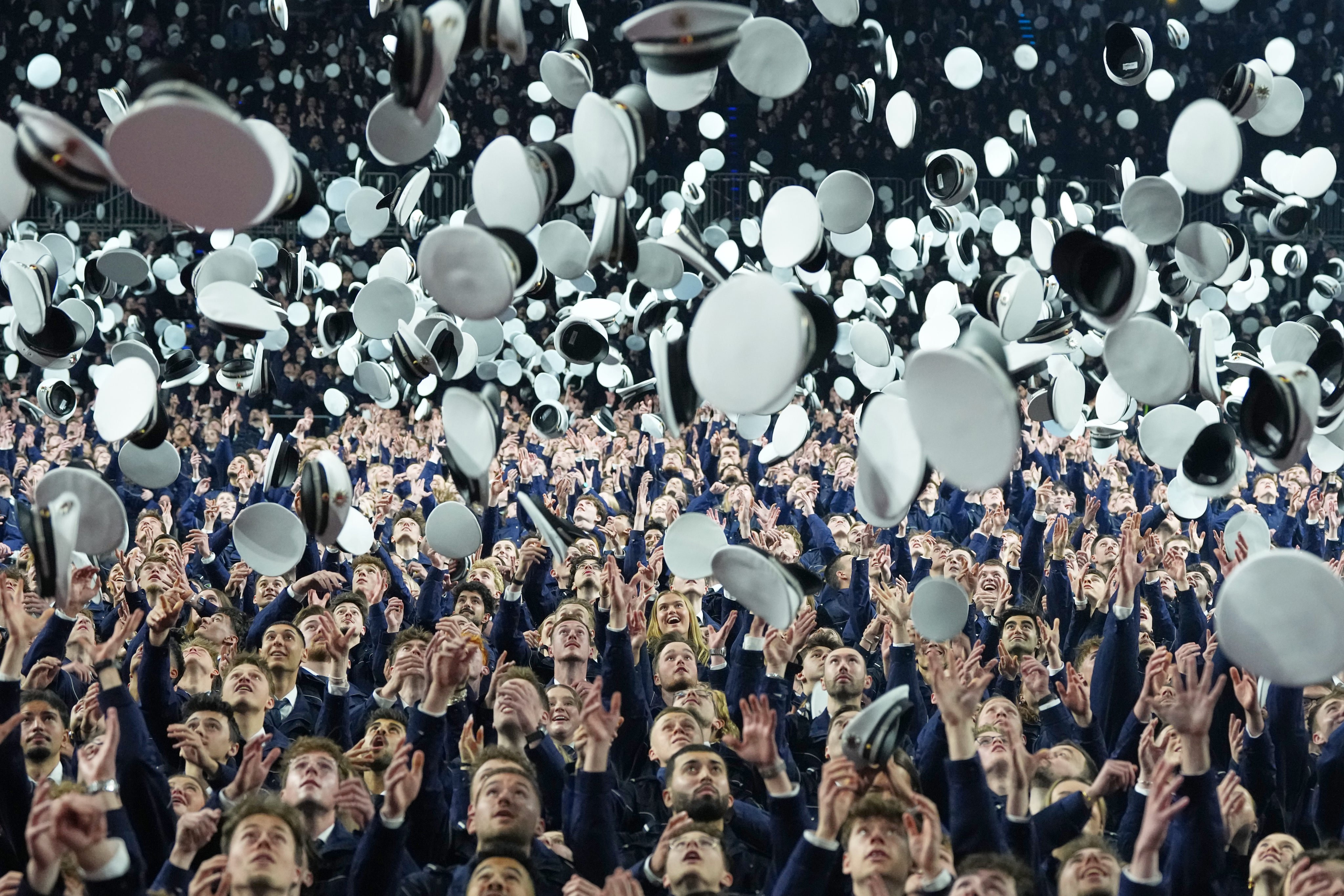 New German police trainees throw their hats after taking their oath of service in Cologne, Germany. Photo: AP