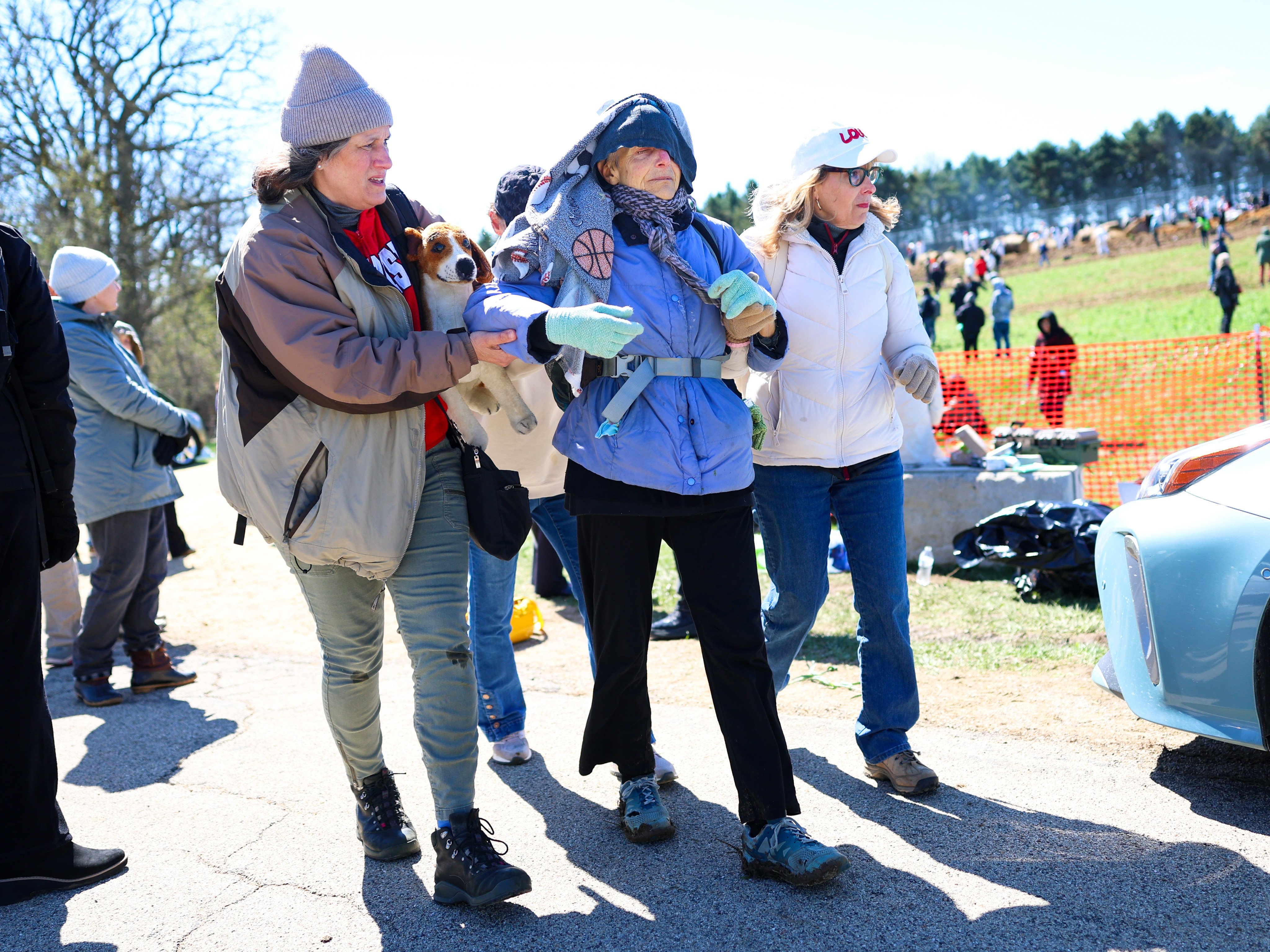 Activists help an elderly woman after she had been tear gassed during an attempt to gain entry into Ridglan Farms beagle breeding and research facility on Saturday, in Blue Mounds, Wisconsin, US. Photo: AP