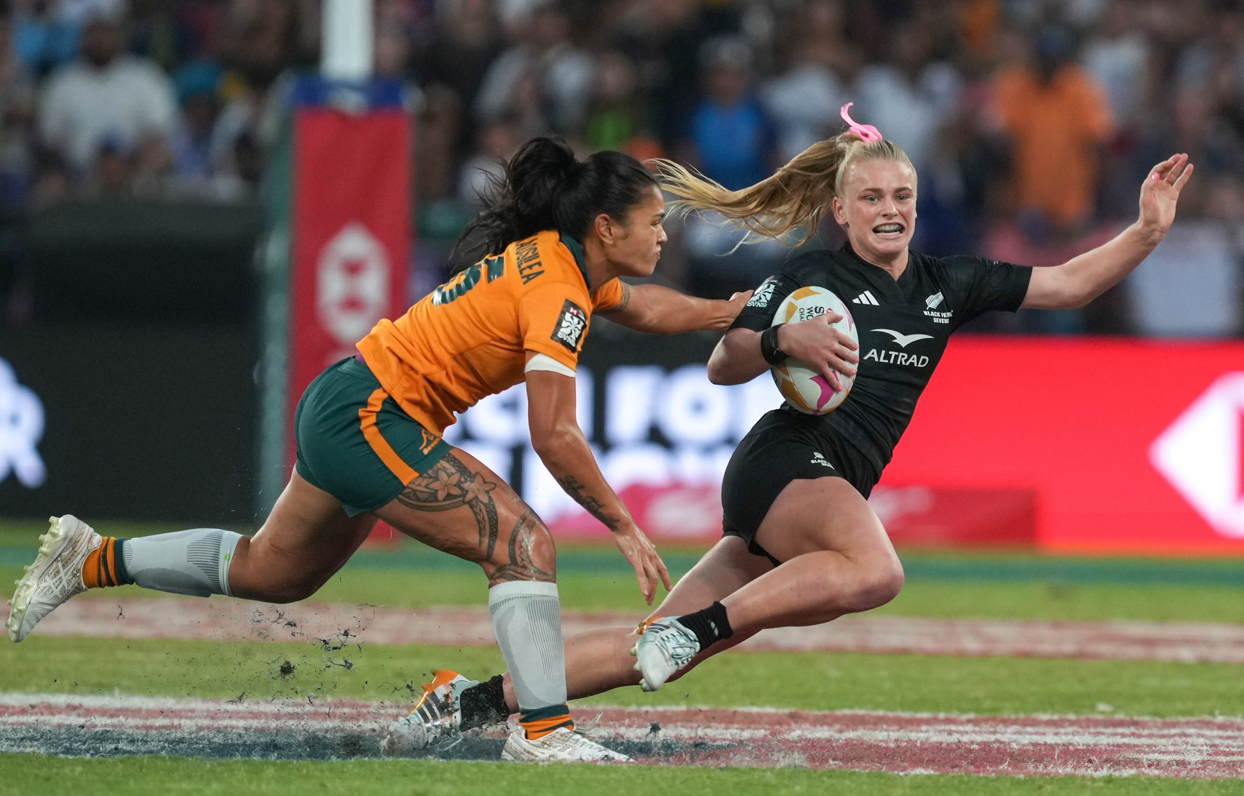 New Zealand’s Jorja Miller (right) evades the tackle of Australia’s Alysia Lefau-Fakaosilea in the Cathay/HSBC Hong Kong Sevens cup final at Kai Tak Stadium on Sunday. Photo: Sam Tsang