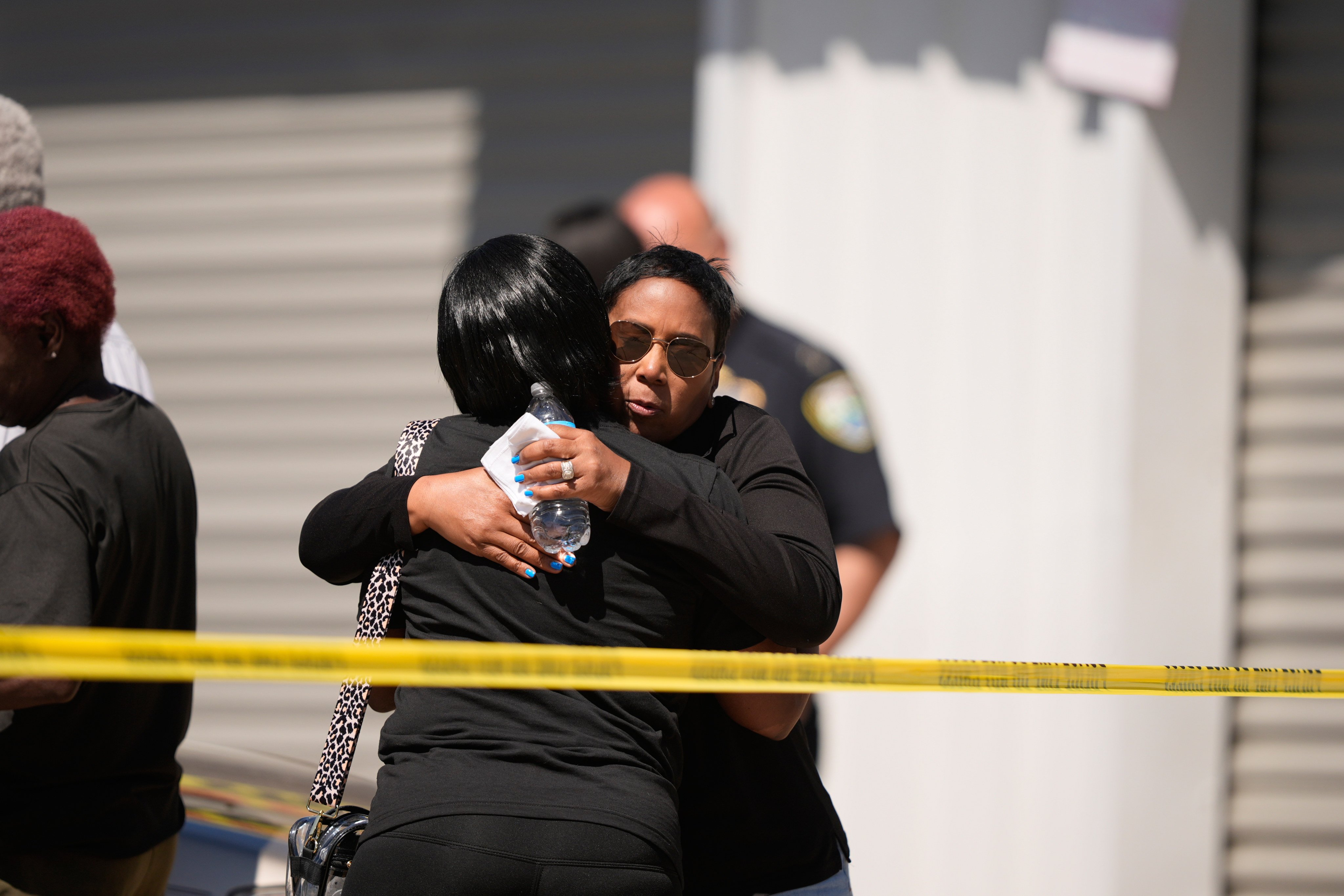 Council woman Tabatha Taylor, right, hugs an unknown person outside the scene of a mass shooting in Shreveport, Louisiana on Sunday. Photo: AP