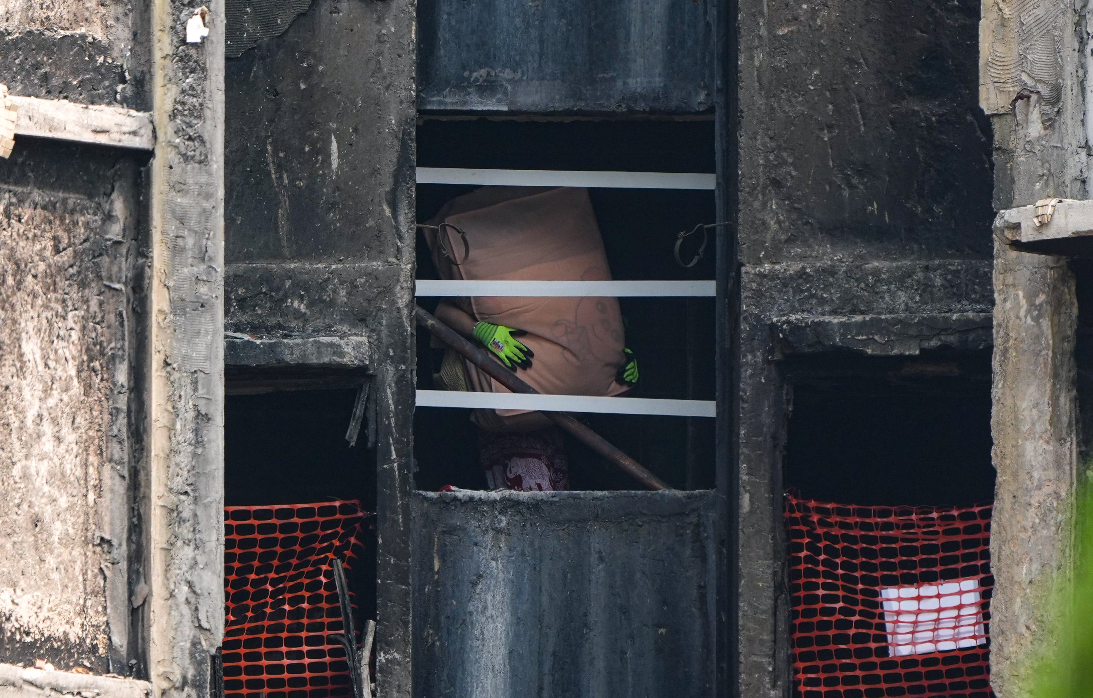Residents retrieve belongings from the fire-ravaged Wang Fuk Court. Photo: Eugene Lee