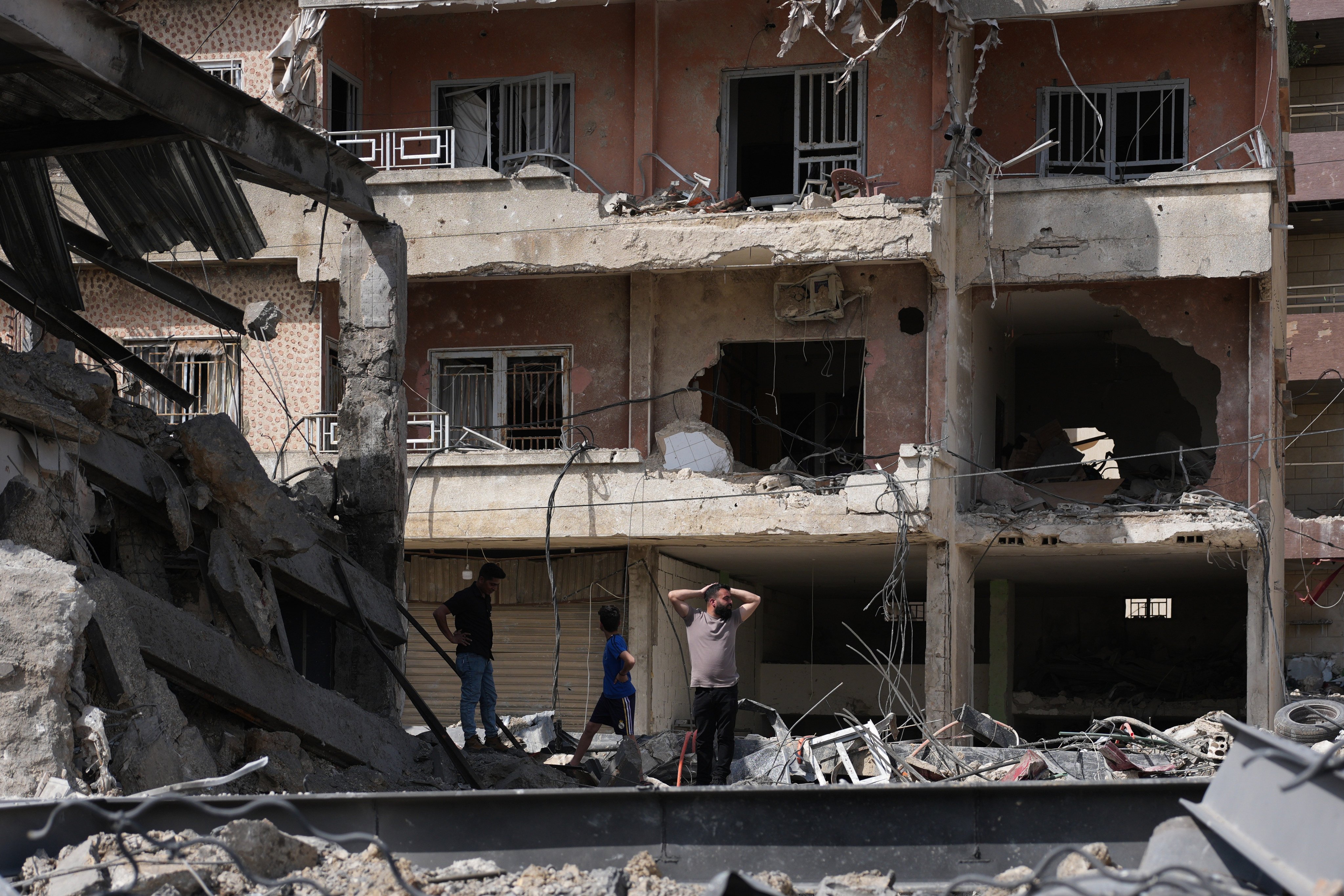 Residents inspect damage at buildings destroyed in Israeli strikes, in Jibchit, southern Lebanon. Photo: AP