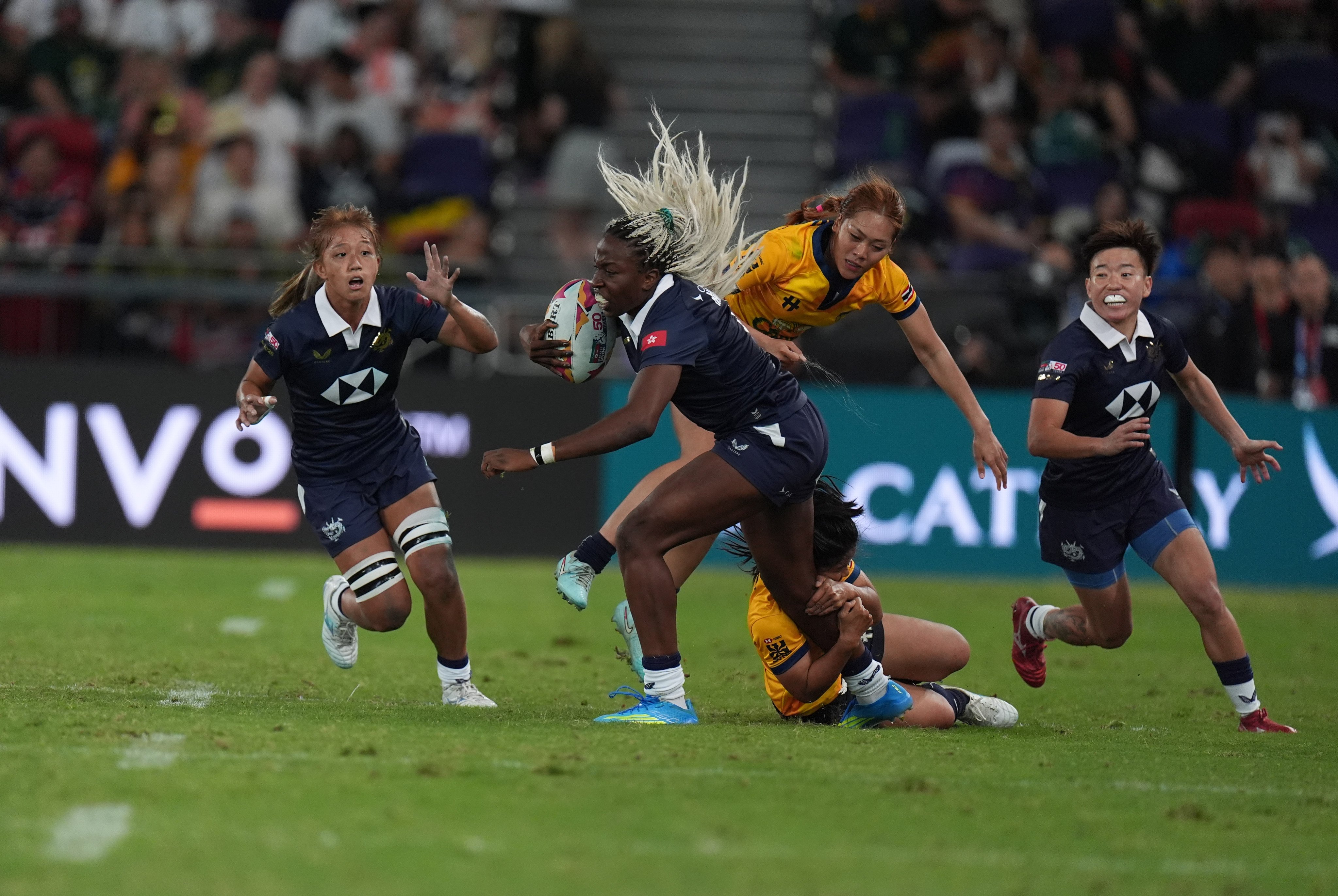 Hong Kong’s Julia Mibuy Mba Oyana (with ball) is tackled by two Thailand players in their match on Saturday while her teammates offer support. Hong Kong lost 24-12. Photo: Elson Li
