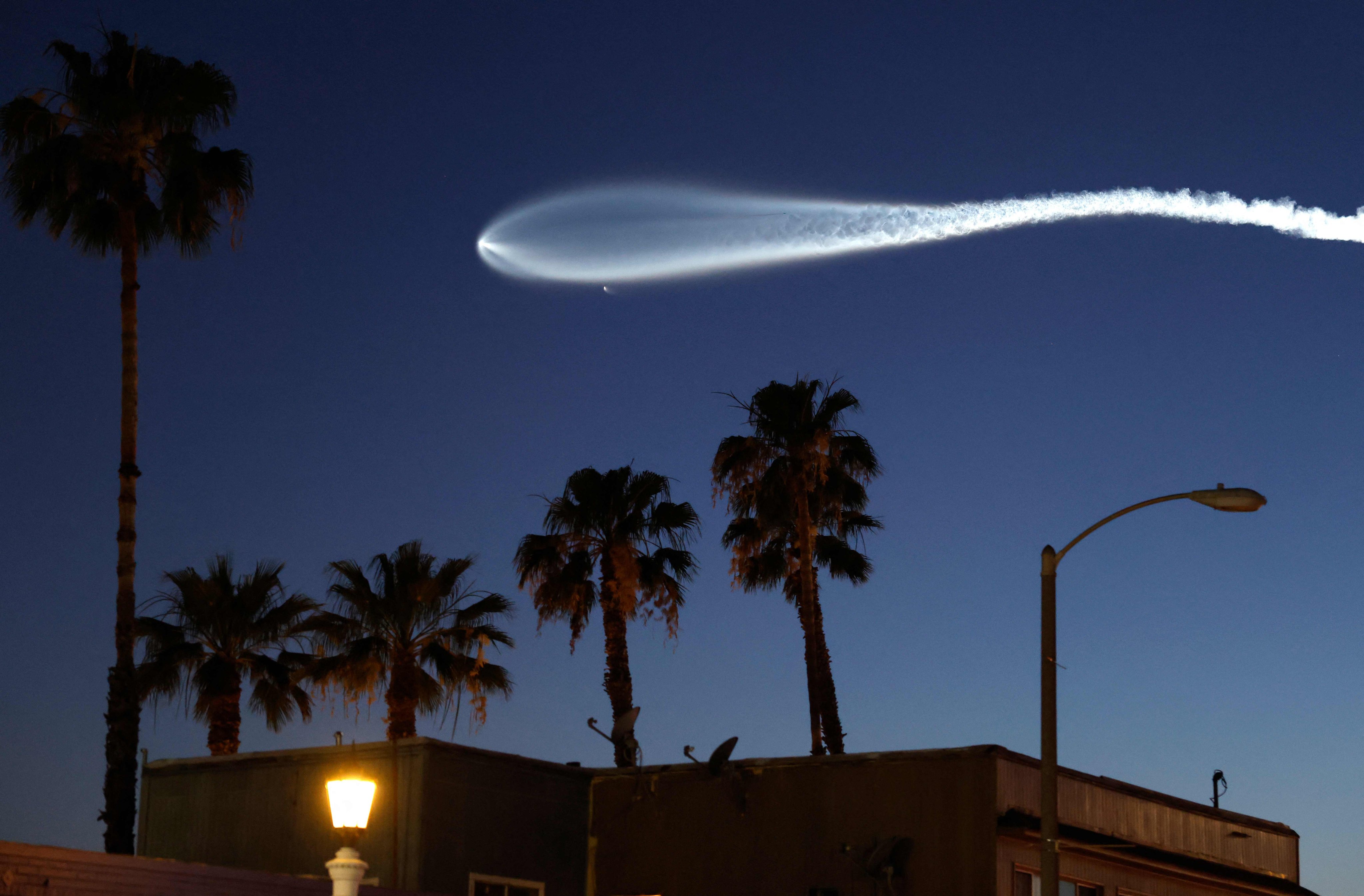 A SpaceX Falcon 9 rocket, carrying 25 Starlink internet satellites, rises after launching from Vandenberg Space Force Base on April 6, 2026. Photo: Getty Images via AFP