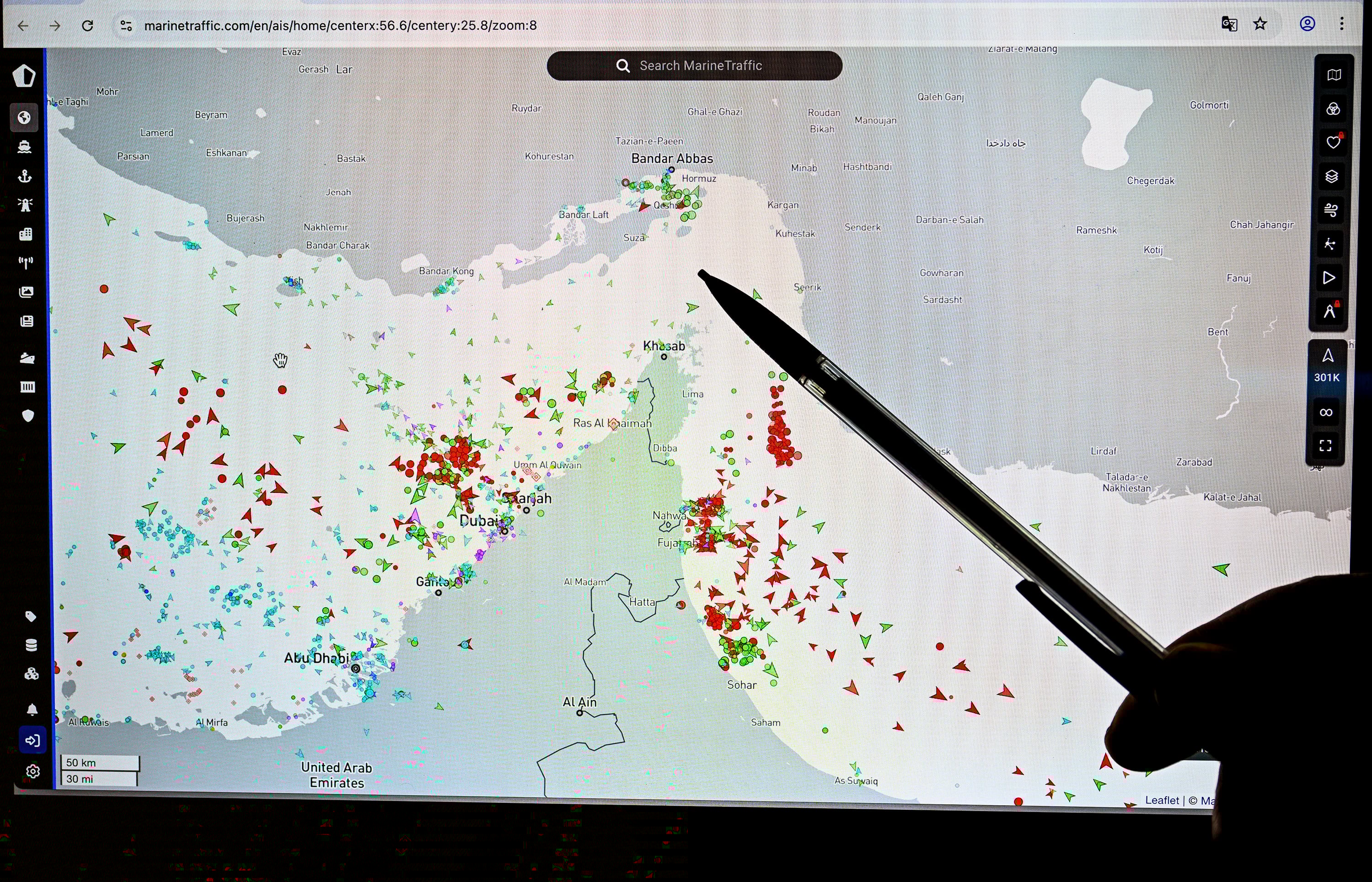 A person points at a page on the Marine Traffic website that shows commercial boats traffic on the edge of the Strait of Hormuz near the Iranian coast, in Paris on March 4. Photo: TNS