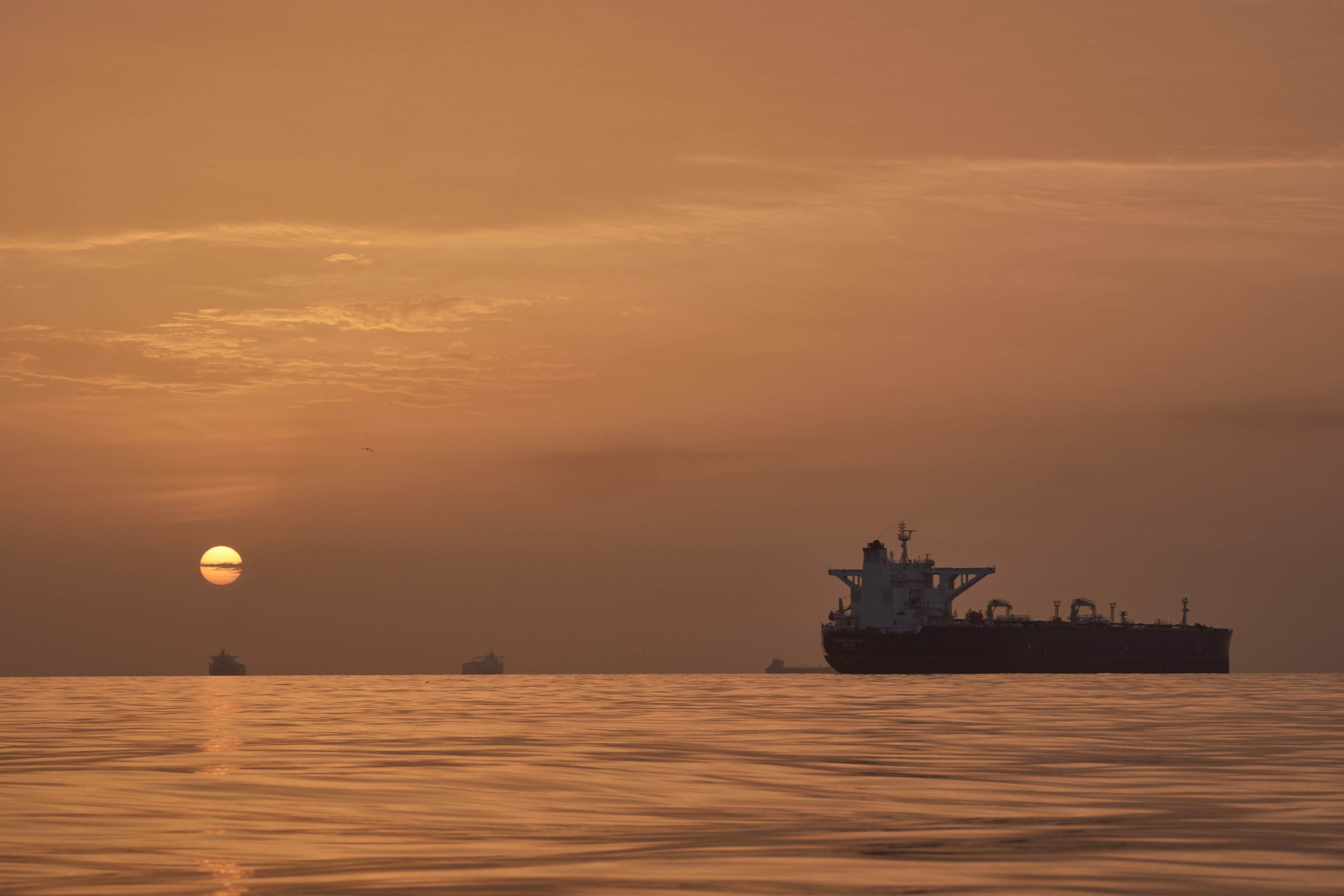 The sun rises behind tankers anchored in the Strait of Hormuz off the coast of Qeshm, an island in Iran, on April 18. Photo: AP
