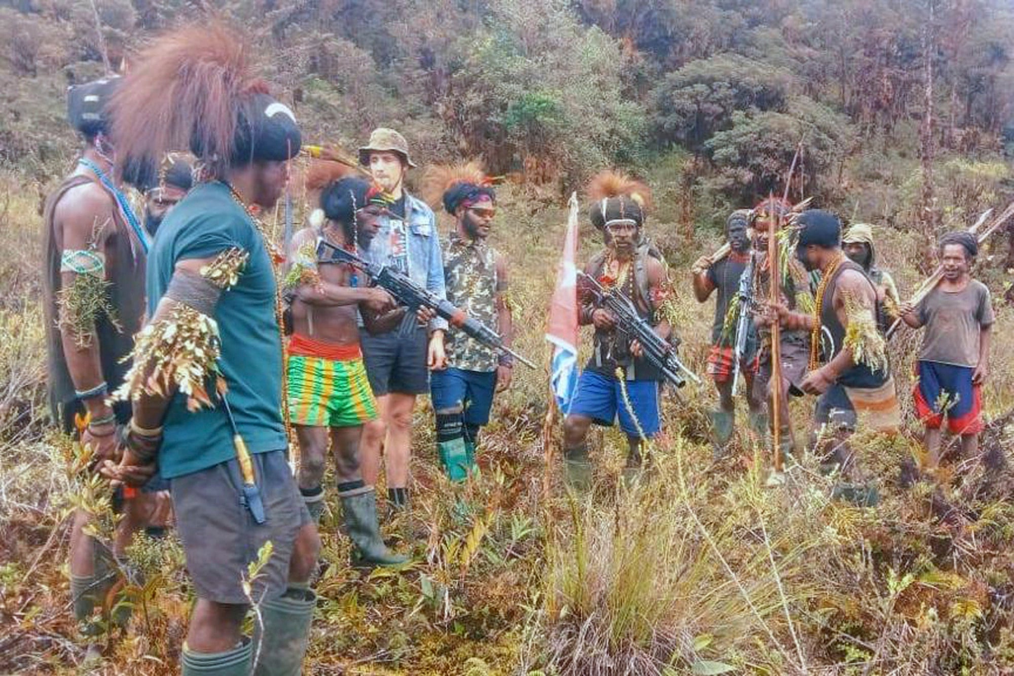 Papuan separatist rebels pose with Phillip Mark Mehrtens, whom they took hostage in February 2023. Photo: West Papua Liberation Army/AP
