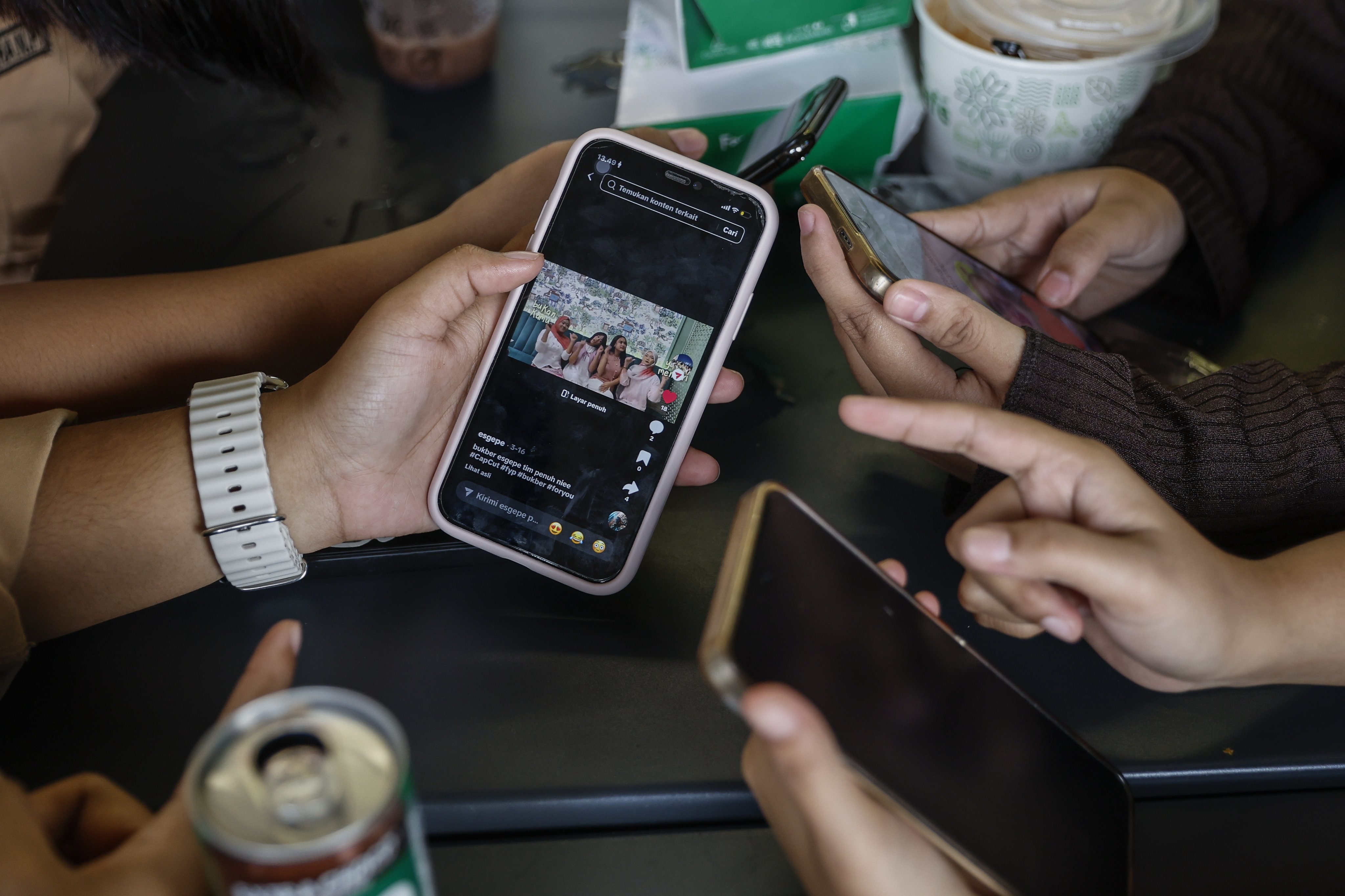 Teenagers browse TikTok in Jakarta, Indonesia. According to the country’s Communication and Digital Affairs Minister Meutya Hafid, TikTok has deactivated 780,000 accounts belonging to users under the age of 16, following a new ban. Photo: EPA