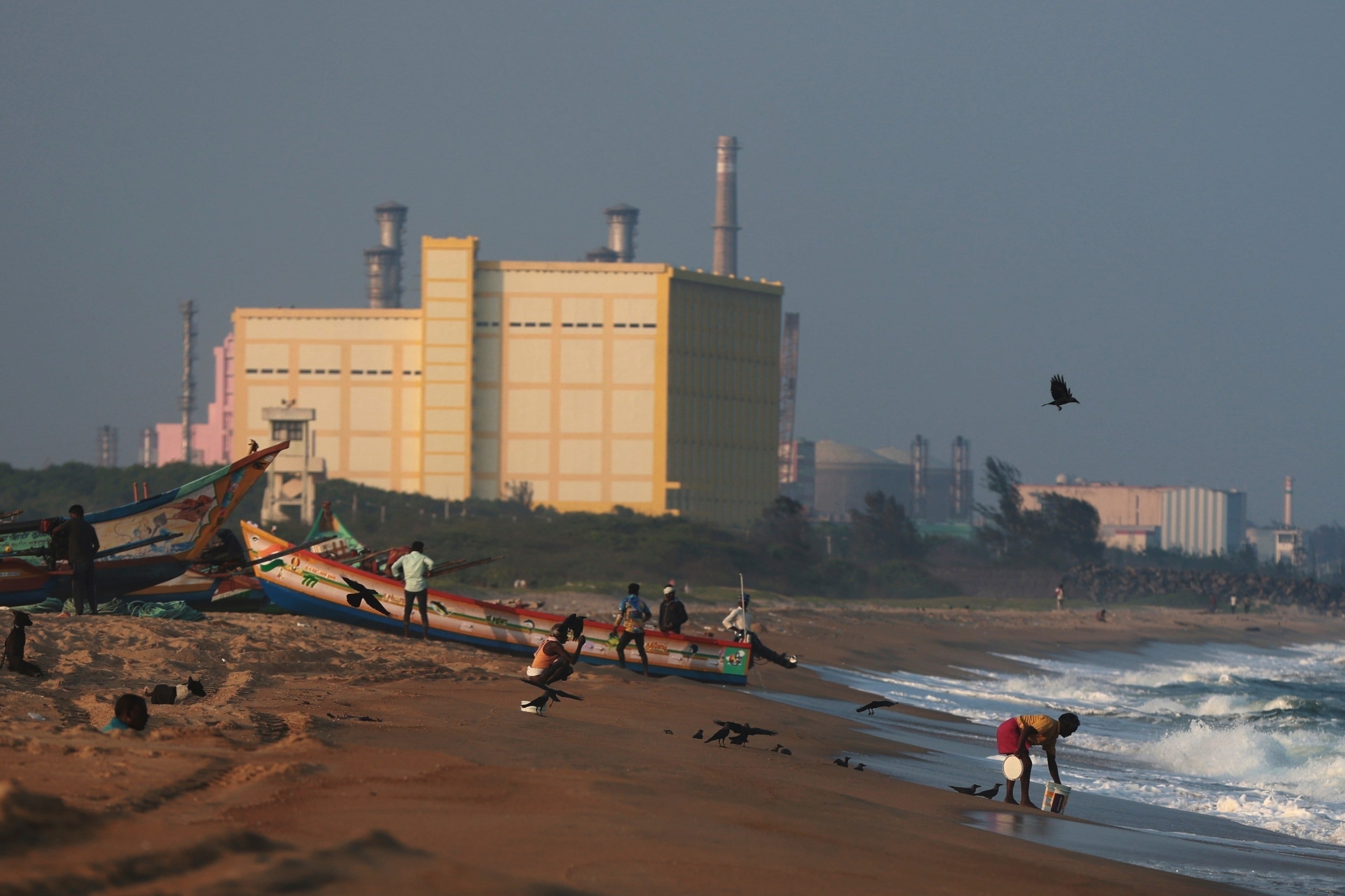 Fishermen pull their boats to the shore near the Kalpakkam atomic power station in Tamil Nadu. Photo: AP