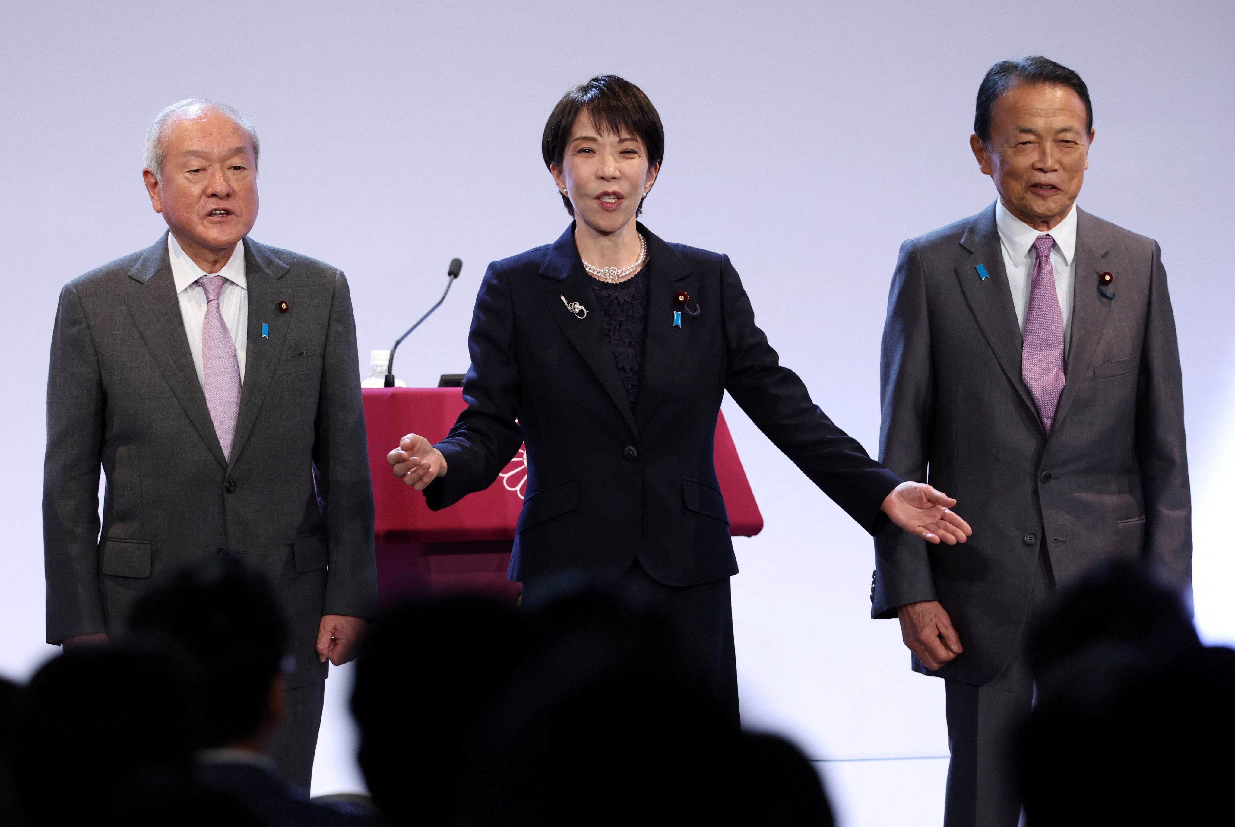 Japan’s Prime Minister Sanae Takaichi, who is also the ruling Liberal Democratic Party leader, sings the party anthem with the party’s deputy president and former prime minister Taro Aso (right) and the party secretary general Shunichi Suzuki (left) on April 12. Photo: Reuters