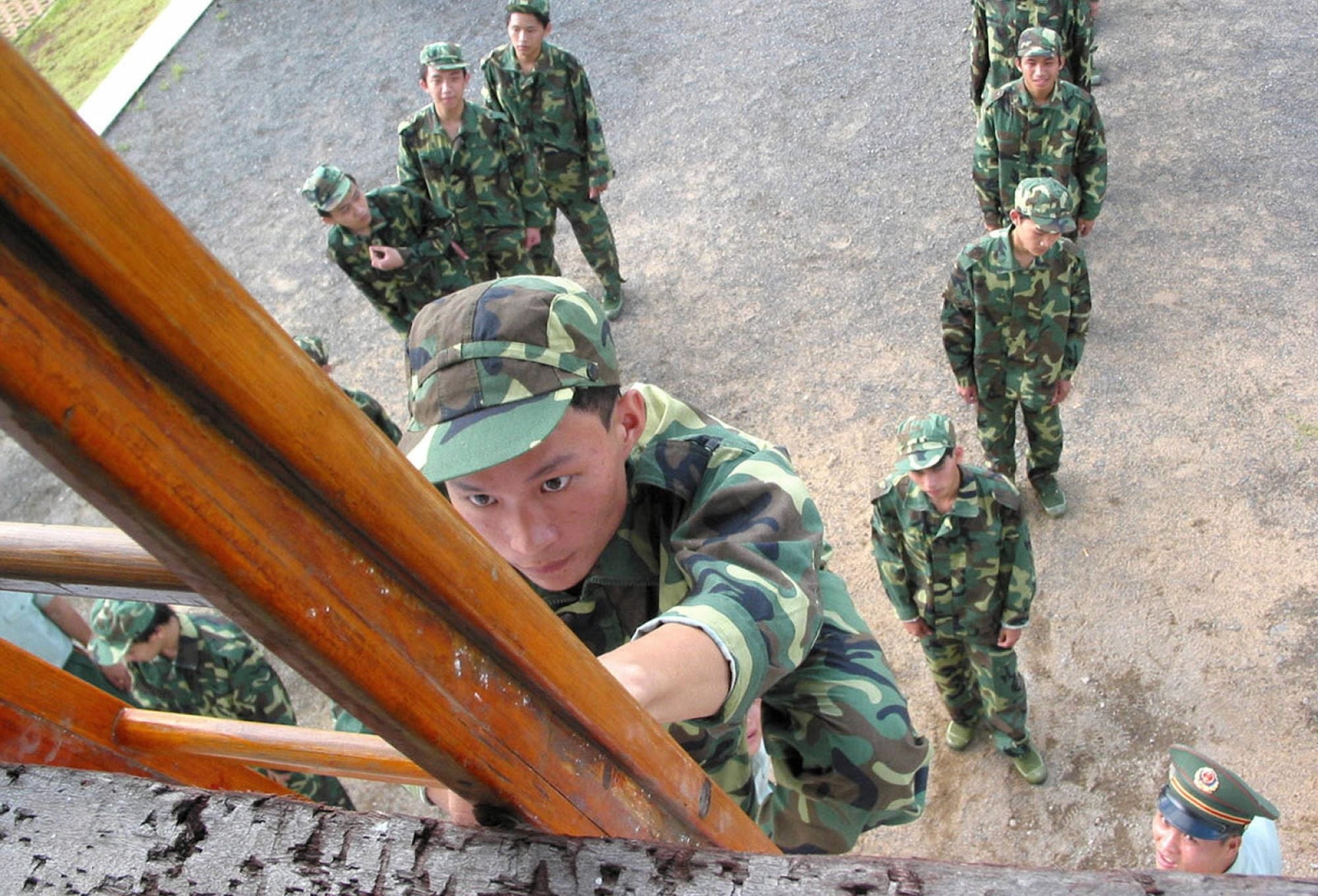 A boy climbs a ladder at a military summer camp for senior secondary school pupils in China. Photo: Xinhua