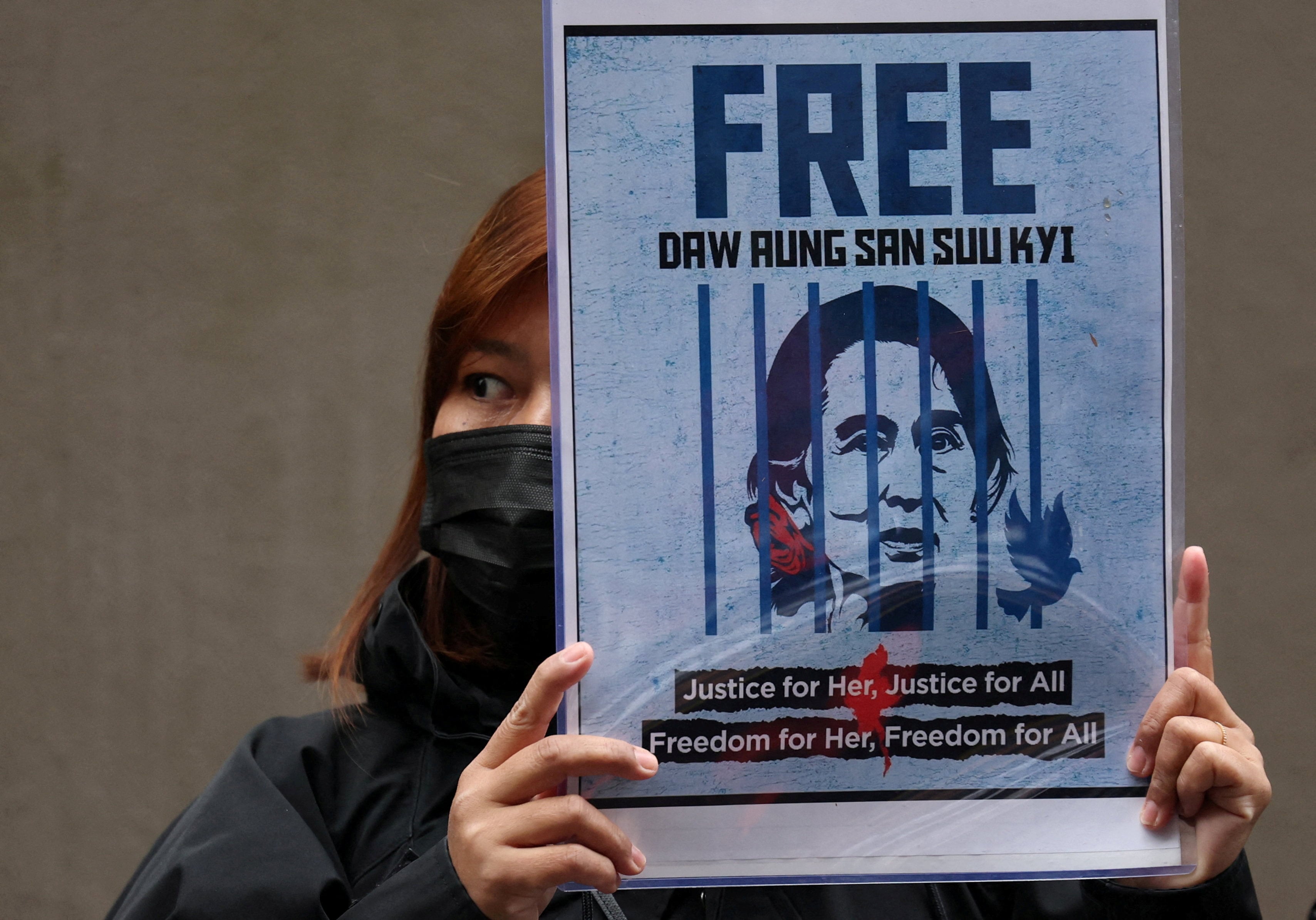 A protester from Myanmar living in Japan holds a placard showing detained former leader Aung San Suu Kyi during a rally in December outside Myanmar’s embassy in Tokyo denouncing the junta’s election. Photo: Reuters