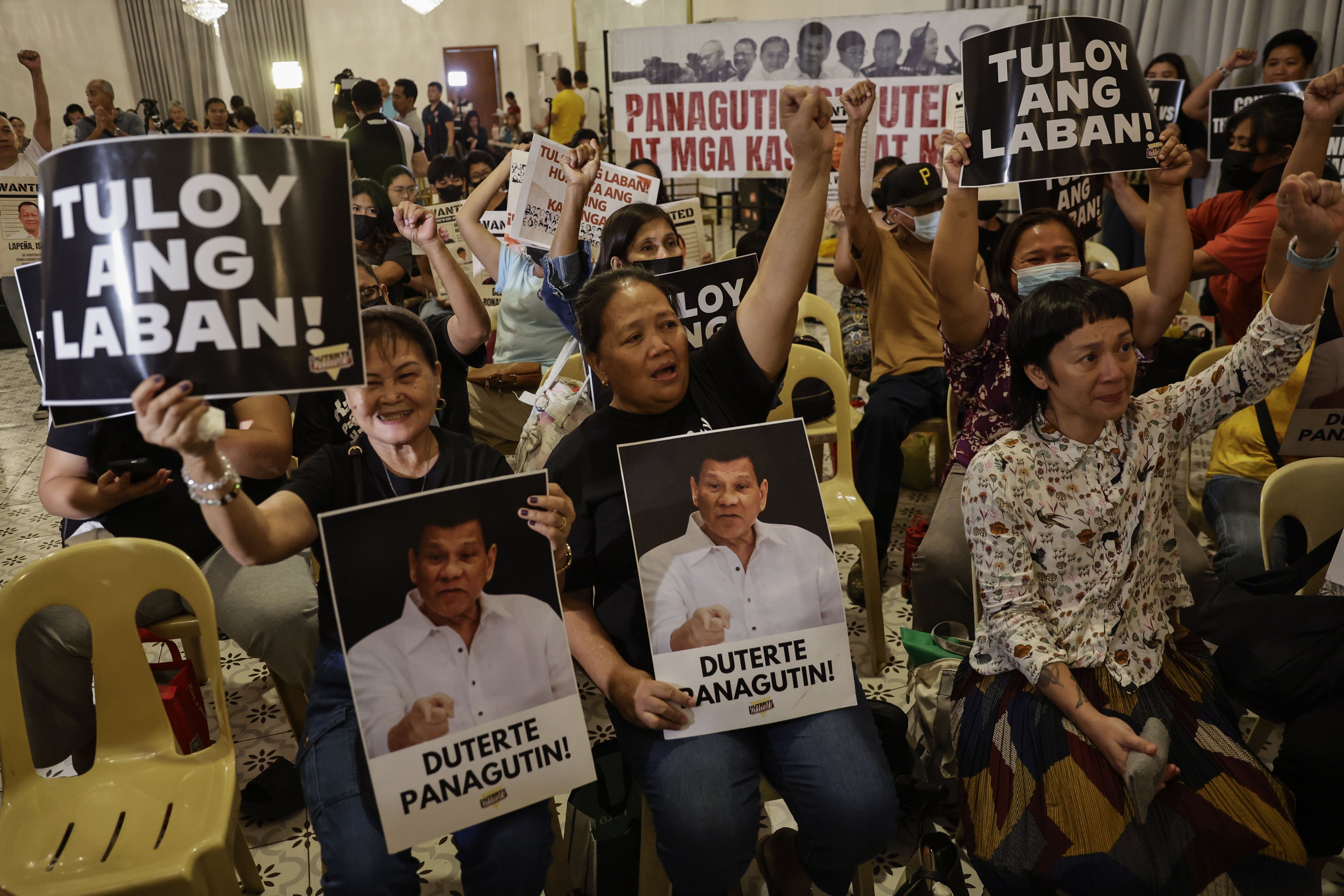 Relatives of victims of ex-Philippine president Rodrigo Duterte’s deadly drug war campaign react after watching a broadcast of the International Criminal Court at a gathering in Quezon City on Wednesday. Photo: EPA