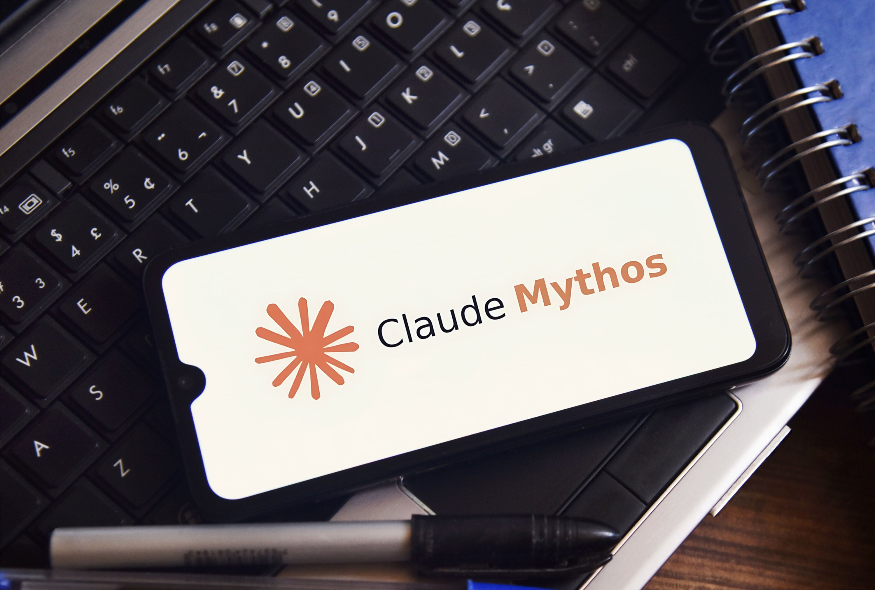 The Claude Mythos logo is displayed on a smartphone screen in this arranged photograph. Photo: Dreamstime/TNS