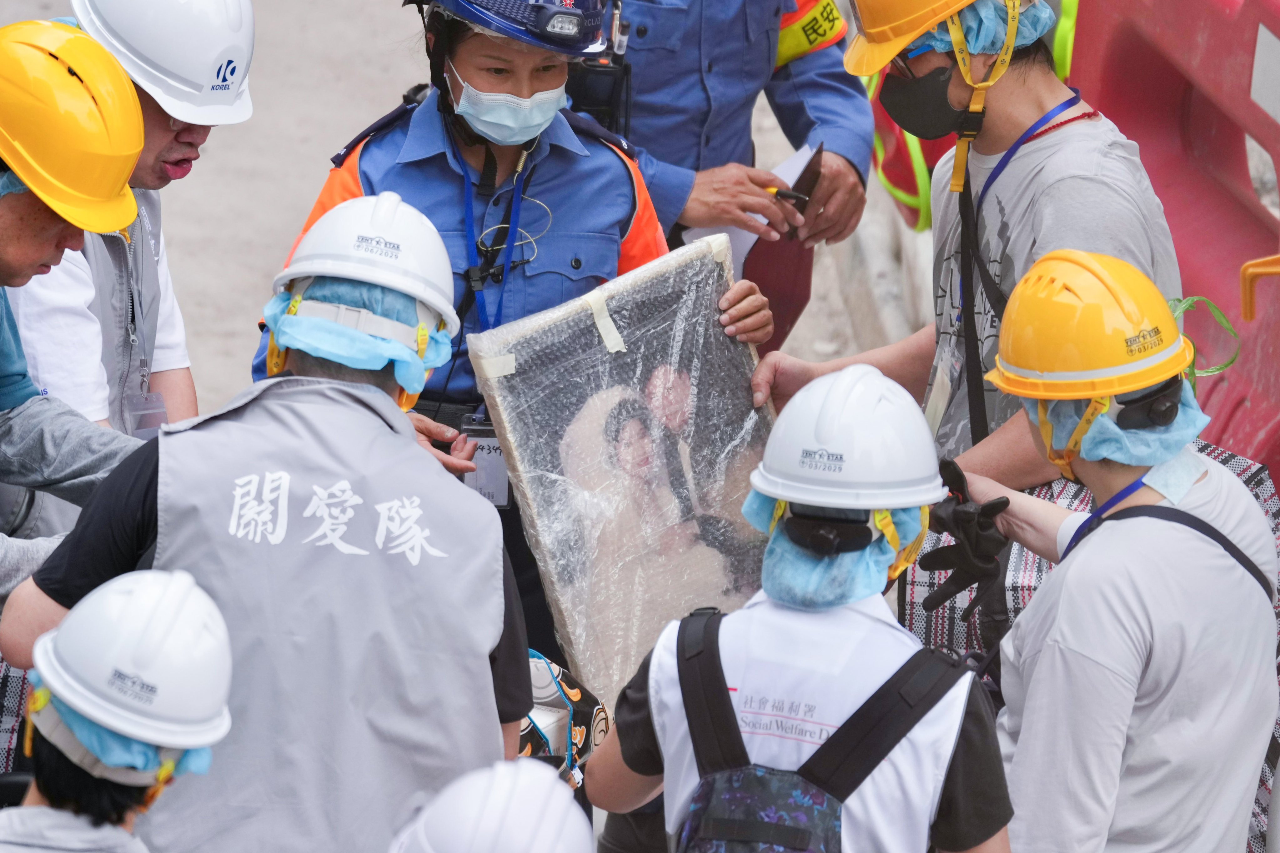 A framed wedding photo has been found as Wang Fuk Court residents return to their flats to pack their belongings. Photo: Karma Lo