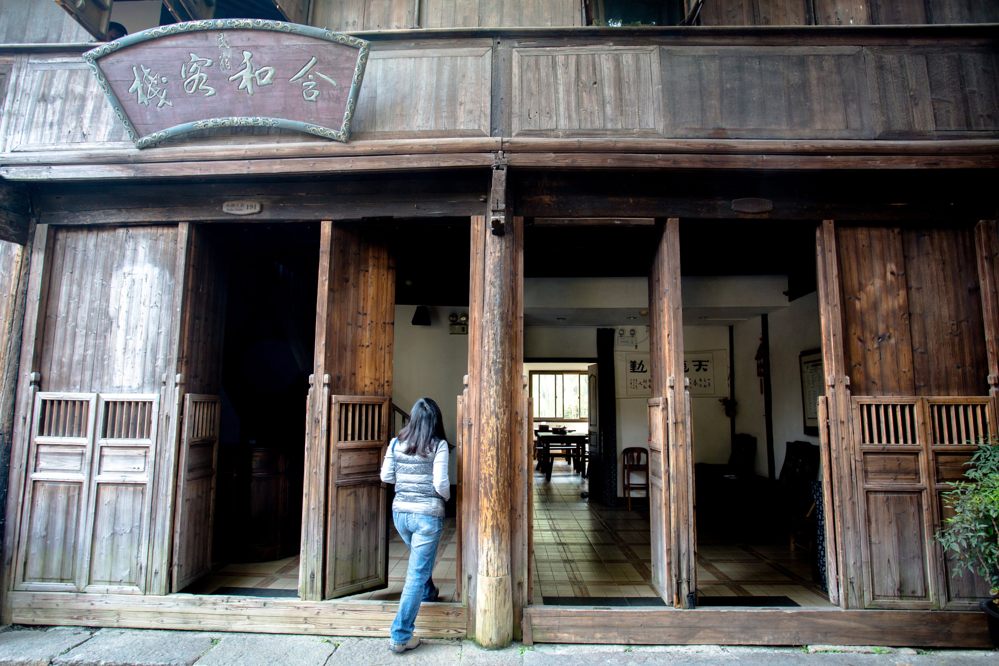 WUZHEN, ZHEJIANG PROVINCE, CHINA - 2014/11/05: A small inn is renovated from an ancient civil house.  Located in the centre of the six ancient towns south of Yangtze River, Wuzhen displays its two-thousand-year history in its ancient stone bridges floating on mild water, its stone pathways between the mottled walls and its delicate wood carvings. It gives a unique cultural experience for tourists. (Photo by Zhang Peng/LightRocket via Getty Images)