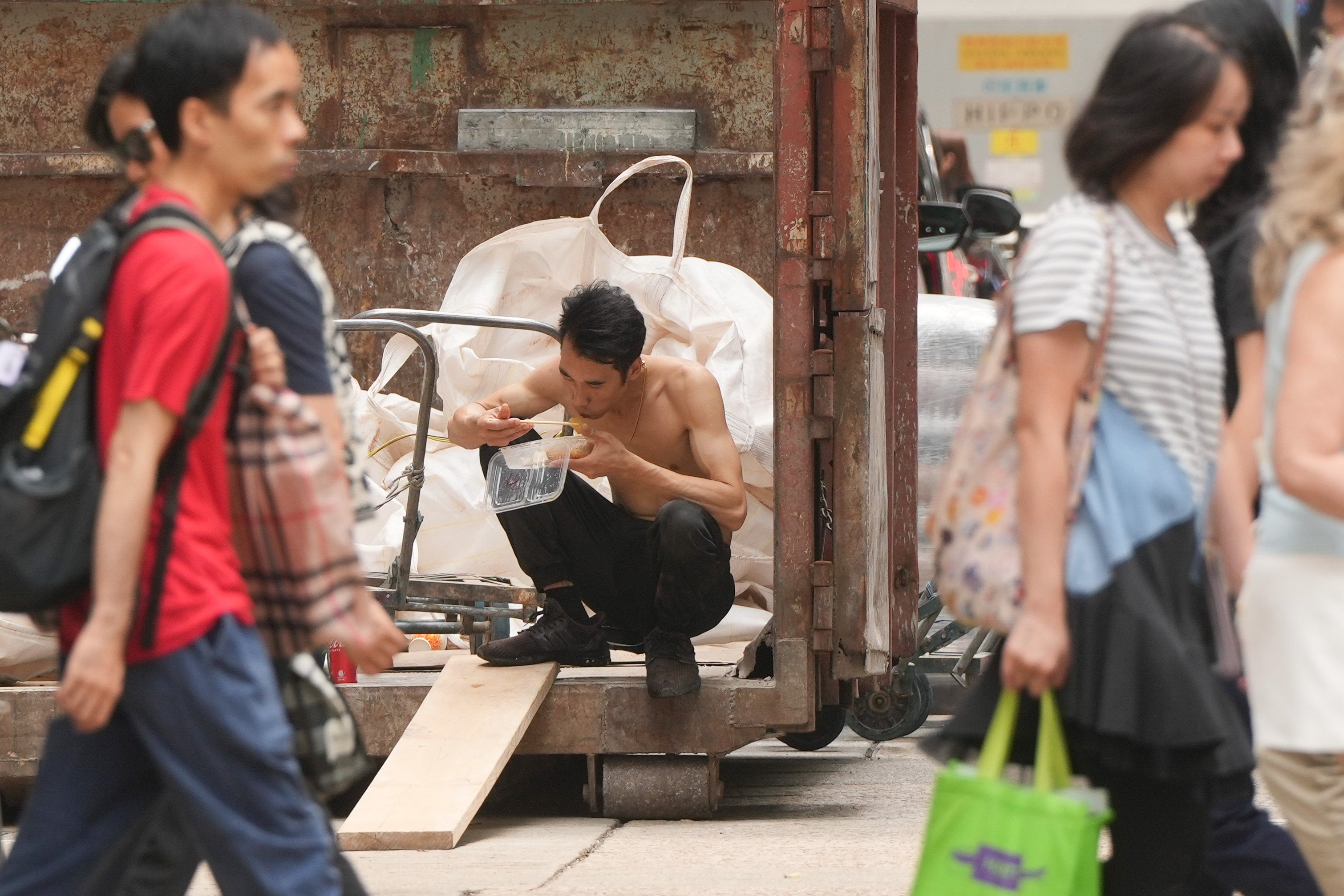 A construction worker eats his lunch in Wan Chai. Photo: Sam Tsang