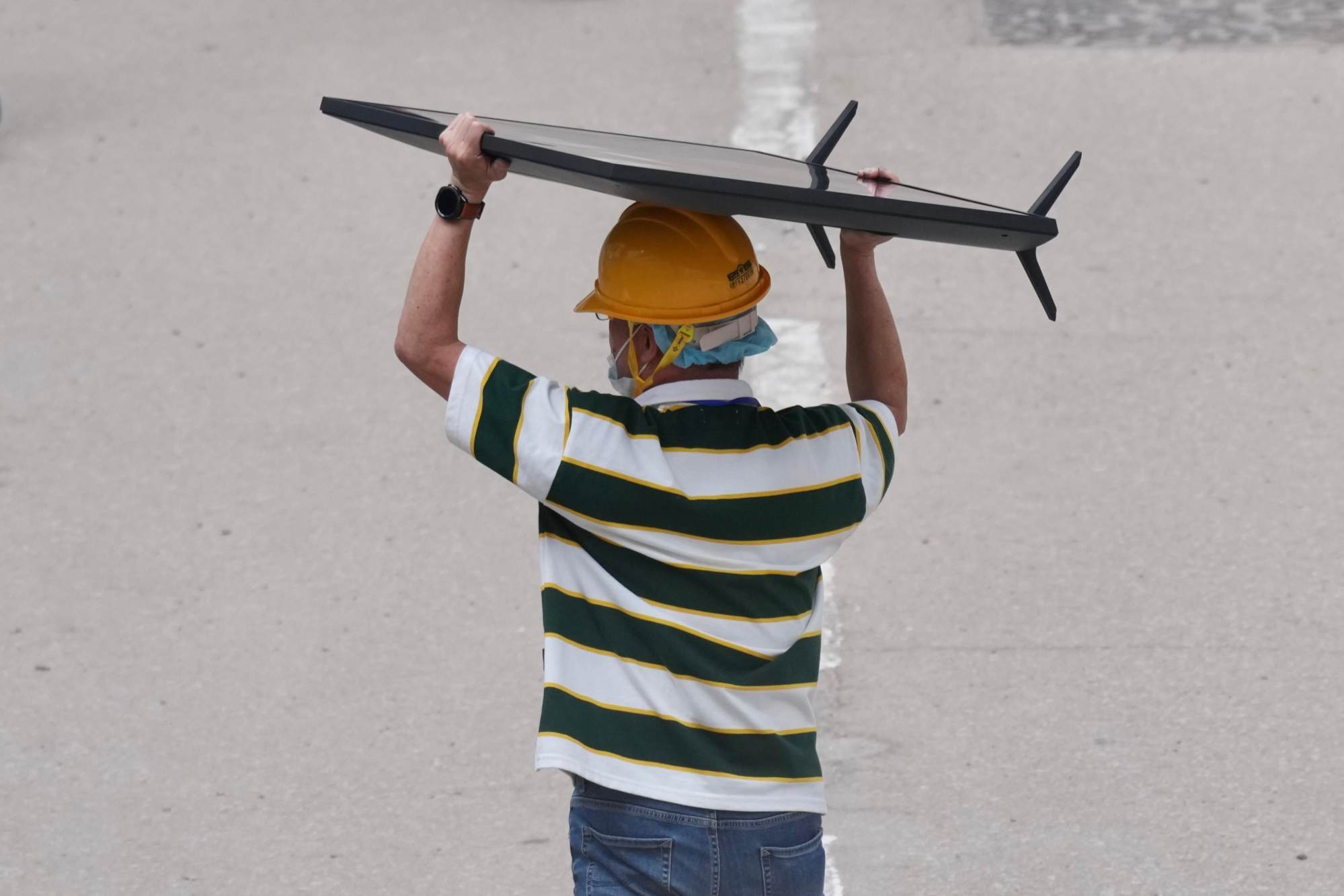 A resident is seen leaving with a television. Photo: Karma Lo