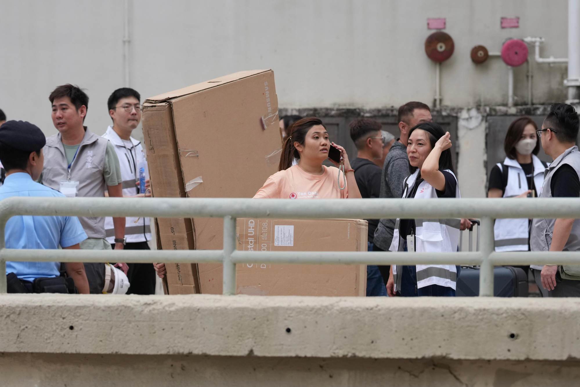 Residents return to their flats with large cardboard boxes to pack their belongings. Photo: Karma Lo