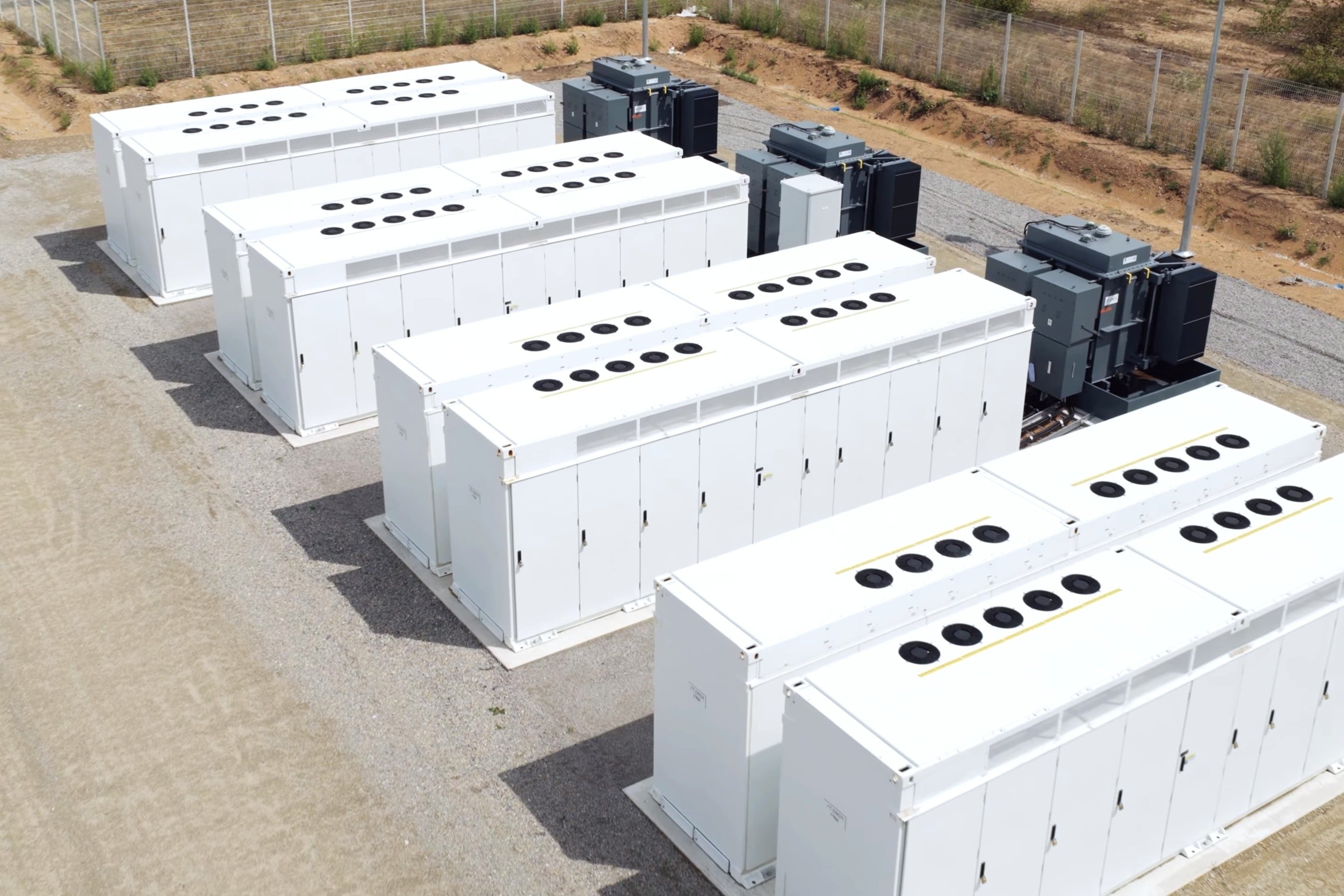 A close-up view of multiple battery energy storage system (BESS) containers in utility installation. They are designed to support renewable integration, load balancing and grid electricity. Photo: Handout