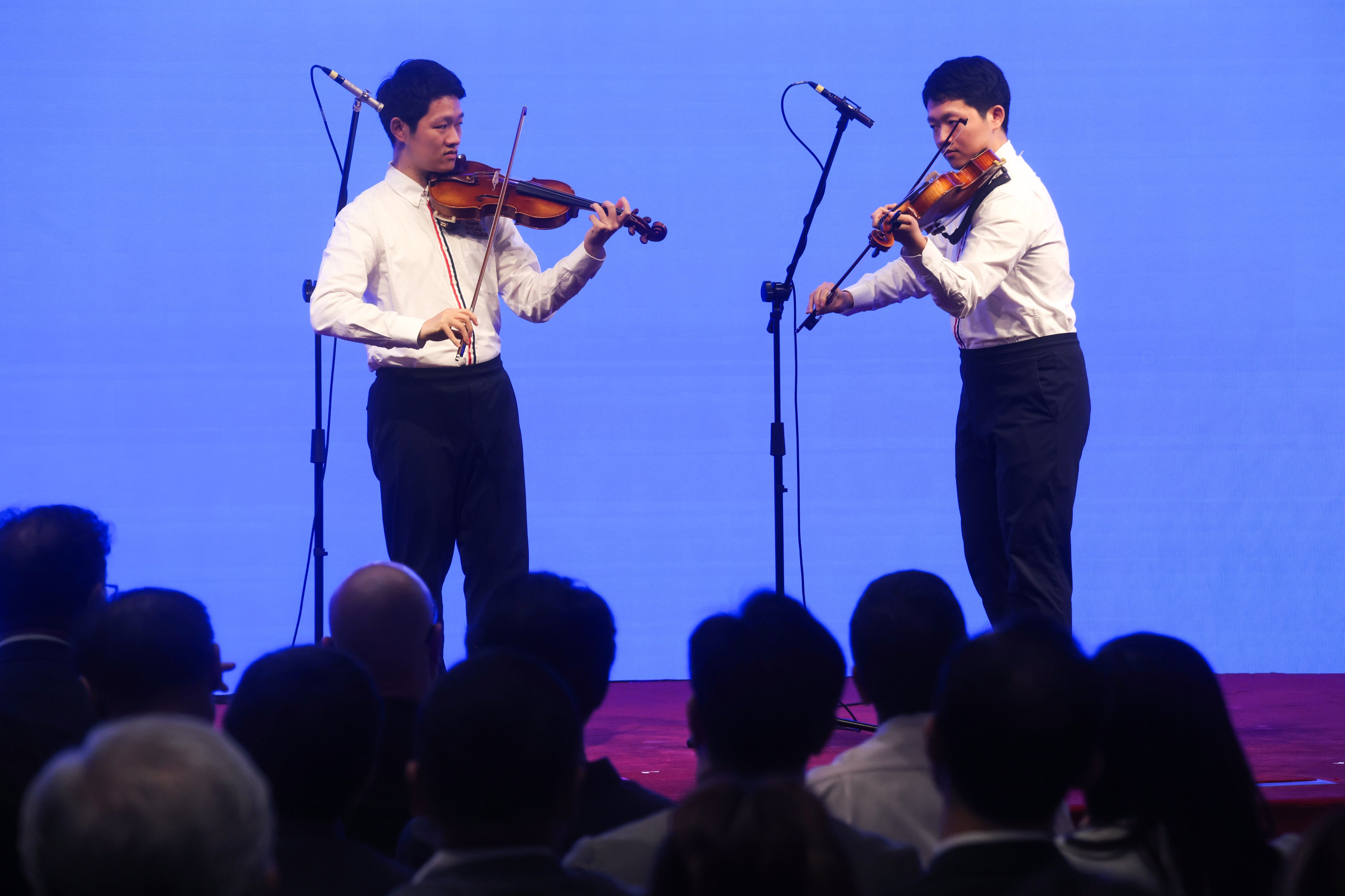 Jayden (left) and Hugo Pang perform at the World Autism Awareness Day 2026 at Hong Kong Exchanges and Clearing (HKEX). Photo: Jonathan Wong