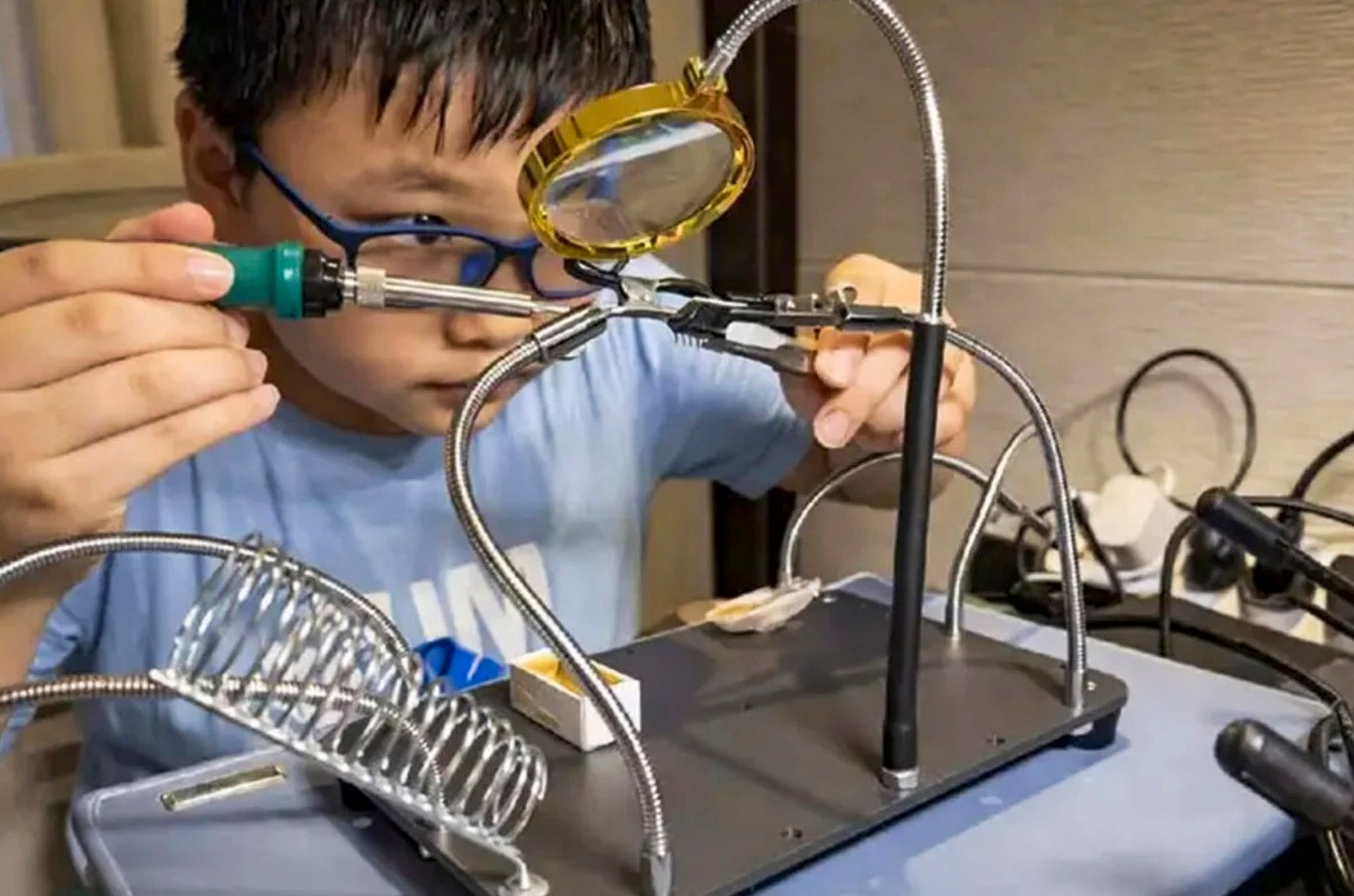 Che, above, is a picture of concentration as he works on his latest project. Photo: Handout