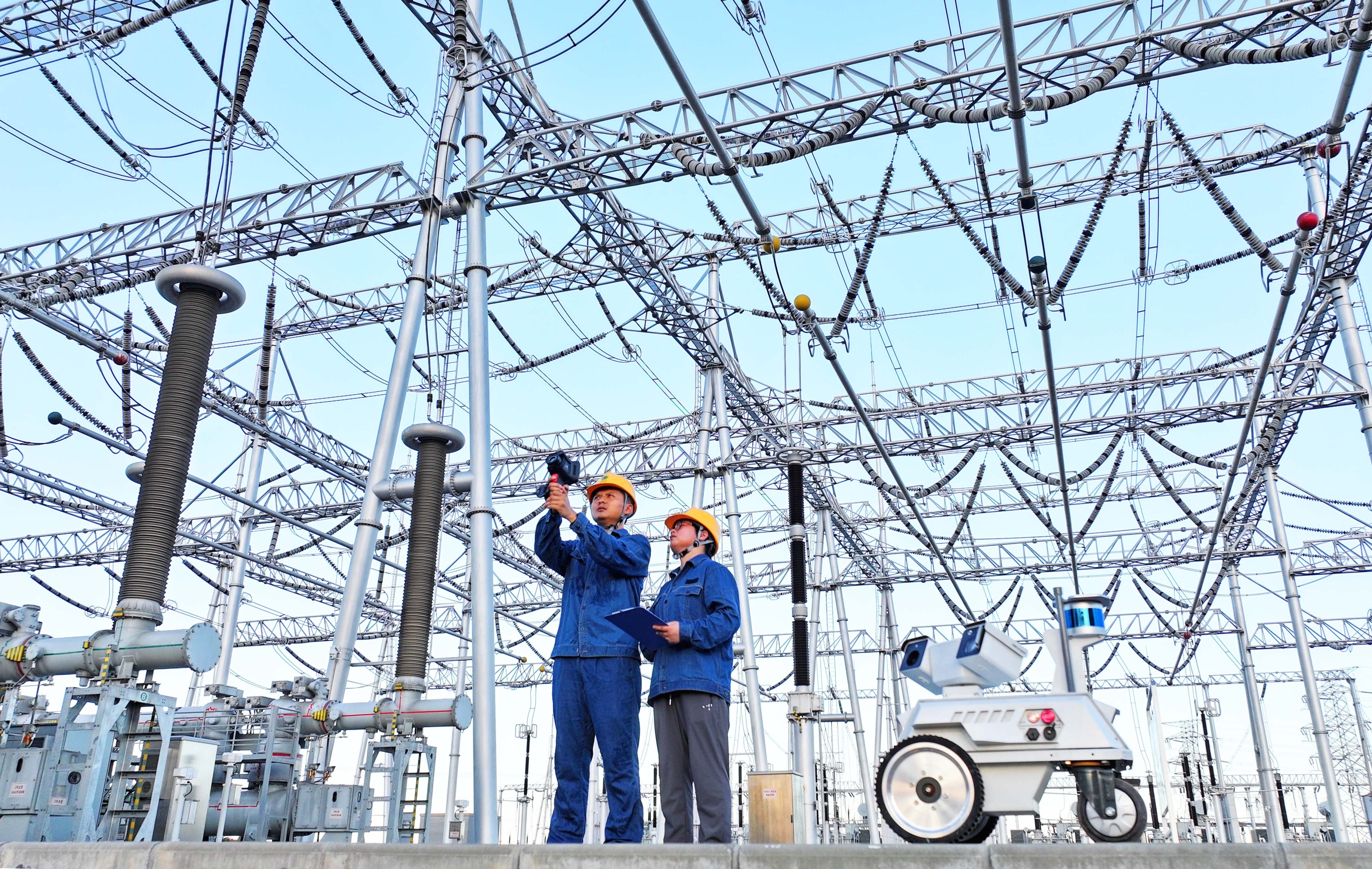 Maintenance personnel inspect a substation with the help of an inspection robot in China’s central Anhui province. Photo: Getty Images