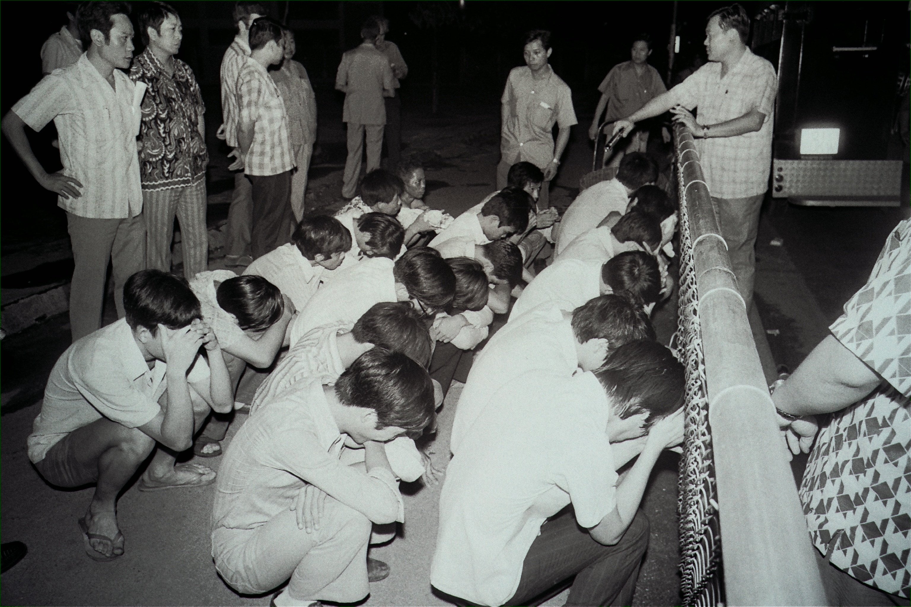 Suspected members of triad societies are guarded by officers in Tung Tau Estate, Kowloon, in 1973. Hong Kong’s triads have evolved from secret societies into global criminal networks. Photo: SCMP