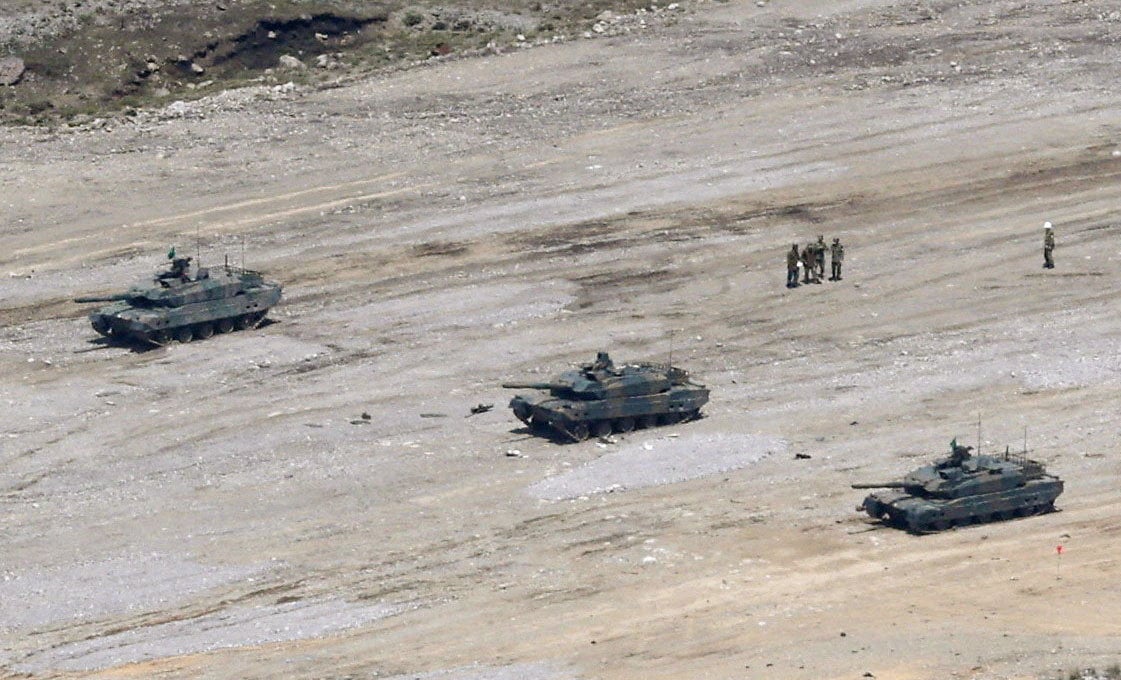 A Japanese Ground Self-Defence Force Type 10 tank (centre) is seen missing its turret after a shell exploded inside on Tuesday. Photo: Kyodo/Reuters