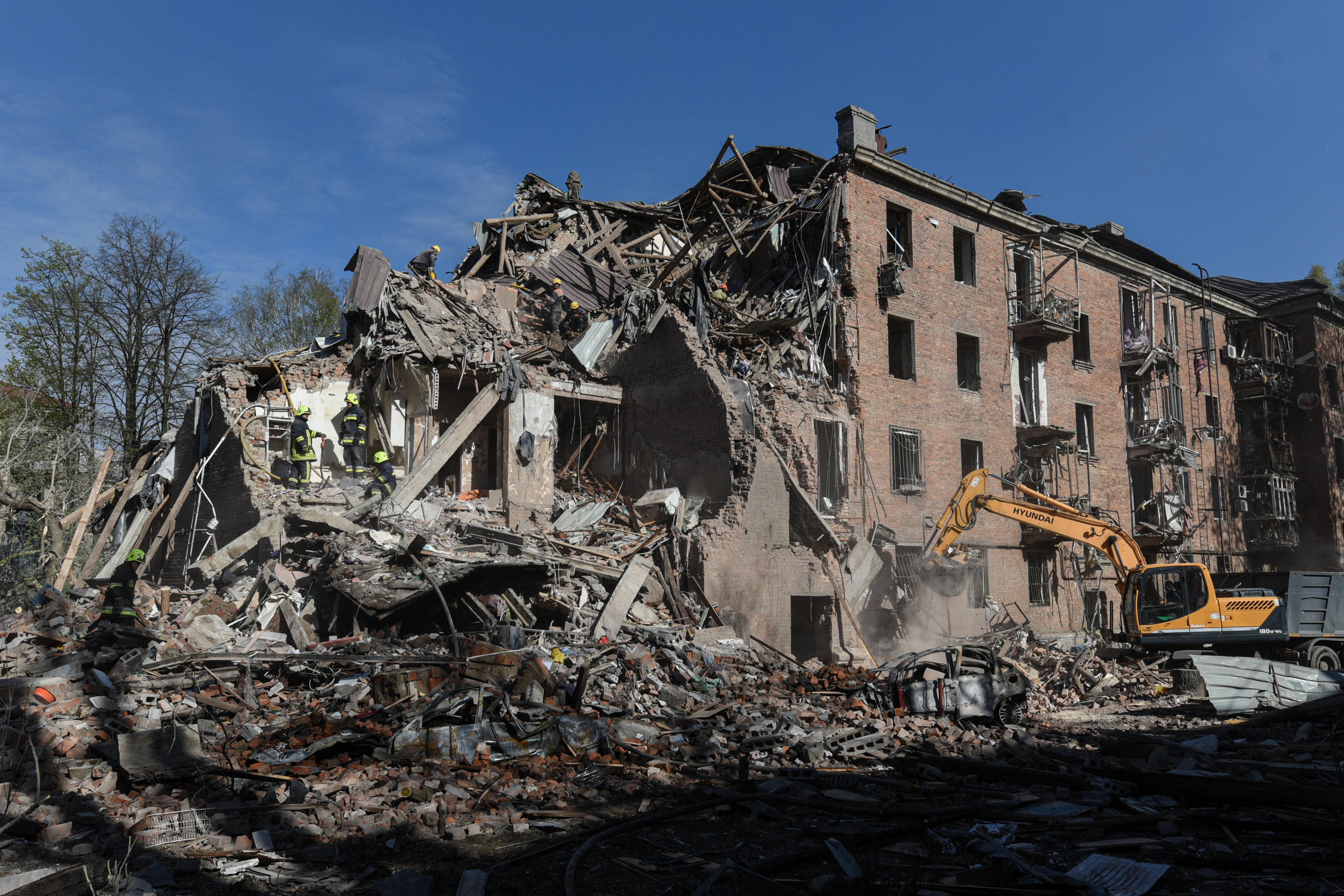 Rescue workers clear the rubble of a residential building destroyed by a Russian strike in Dnipro, Ukraine, on Saturday. Photo: AP