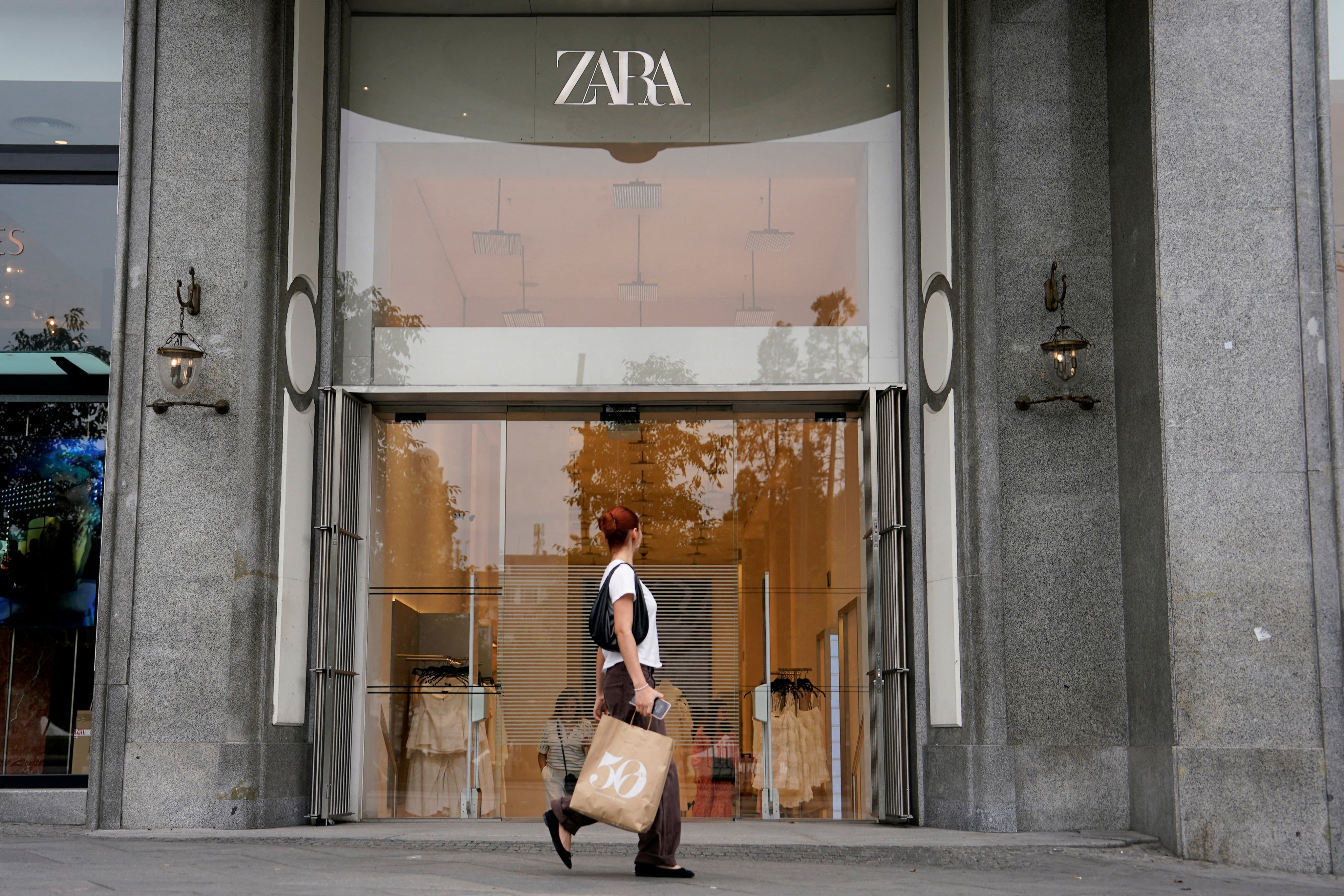 A person carrying a bag walks by a Zara store in Plaza de Espana in Madrid, Spain. Photo: Reuters