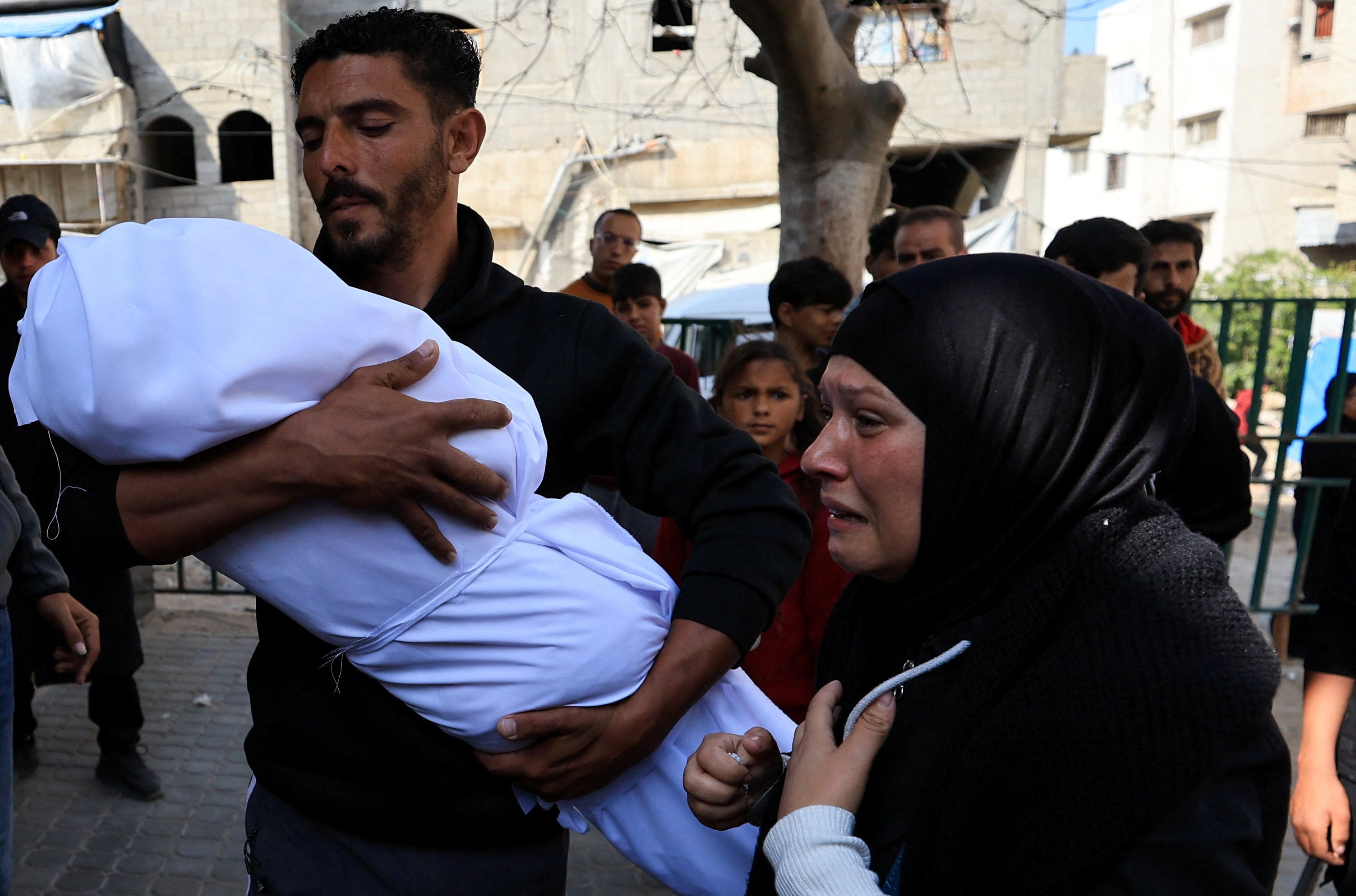 Mourners attend the funeral of Palestinian mother Islam Al-Tanani - who was pregnant with twins - and two of her children Hamza and Naya, all killed in an Israeli strike on Friday. Photo: Reuters