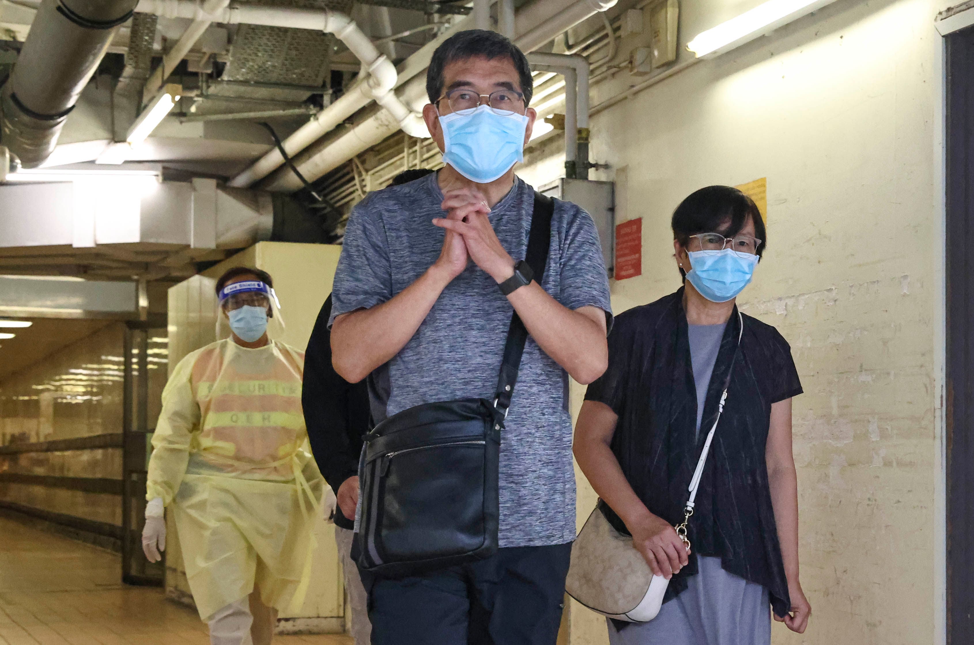 Reverend Derek Li (centre) and his wife leave Queen Elizabeth Hospital a week after their son’s accident in 2022. Photo: K. Y. Cheng
