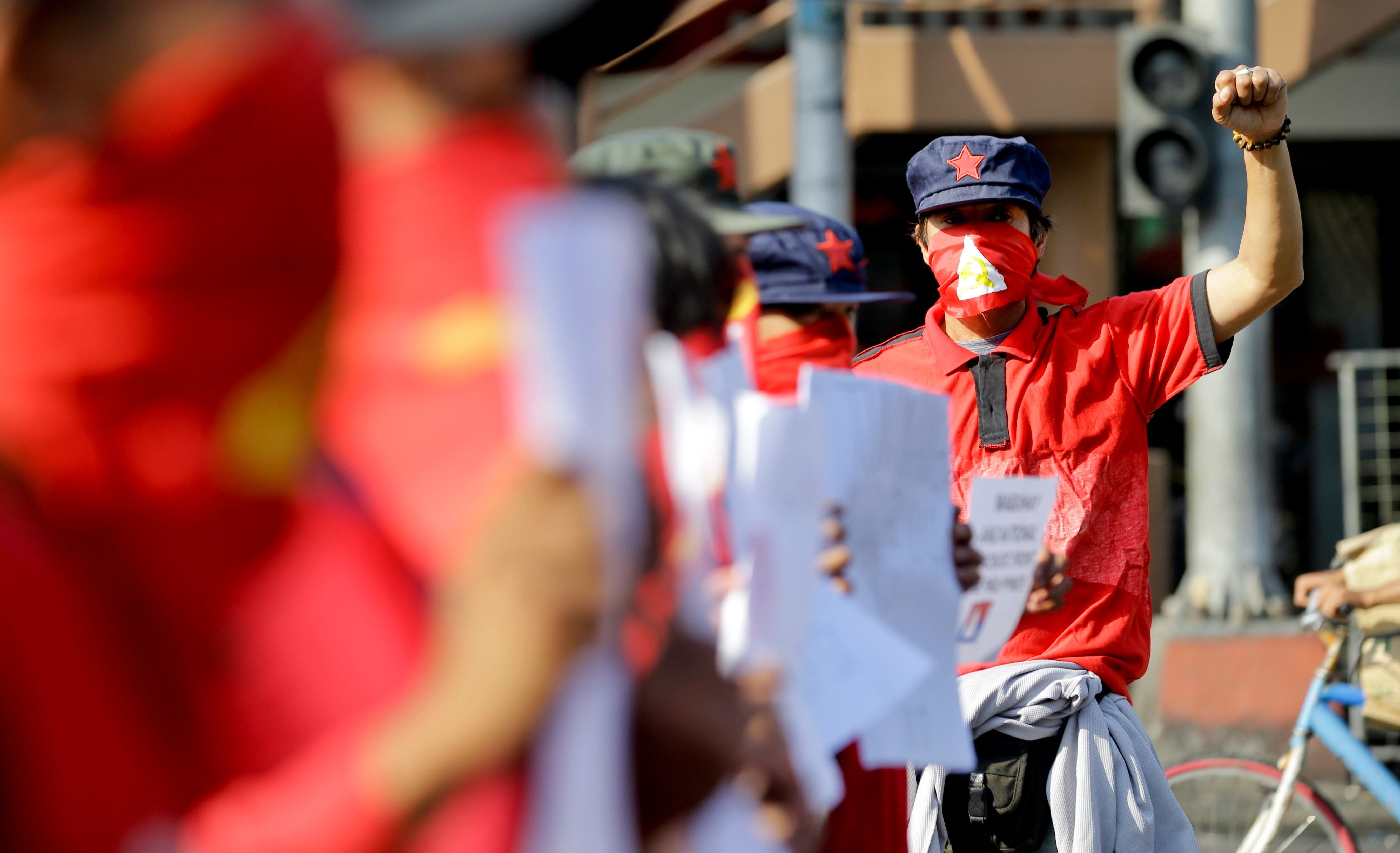 Masked protesters during a rally to commemorate the 49th anniversary of the New People’s Army, the armed wing of the Communist Party of the Philippines, near the Malacanang presidential palace in Manila, Philippines, in 2018. Photo: AP