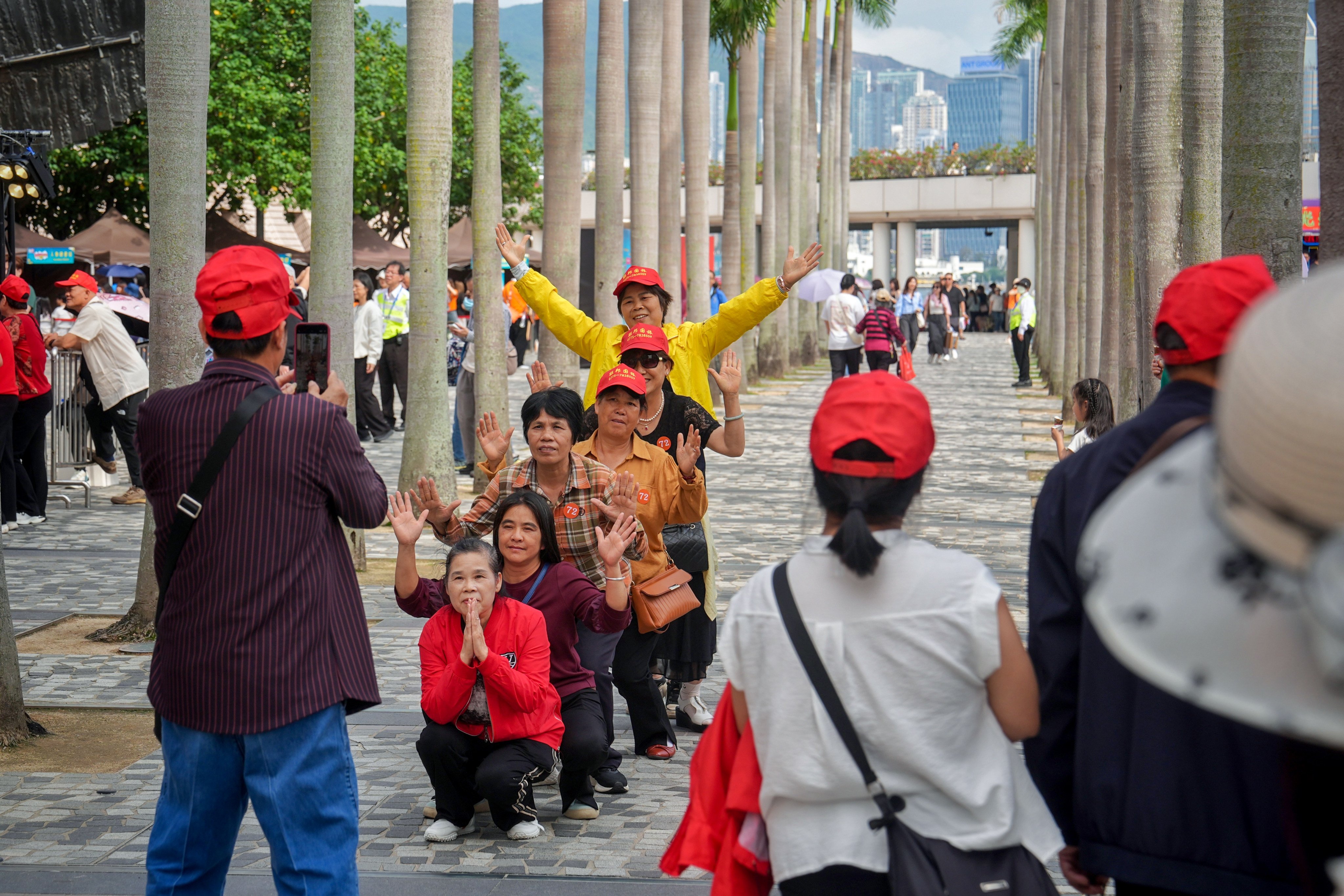 Mainland Chinese tourists pose for pictures outside the Hong Kong Cultural Centre in Tsim Sha Tsui on Saturday. Photo: Elson Li