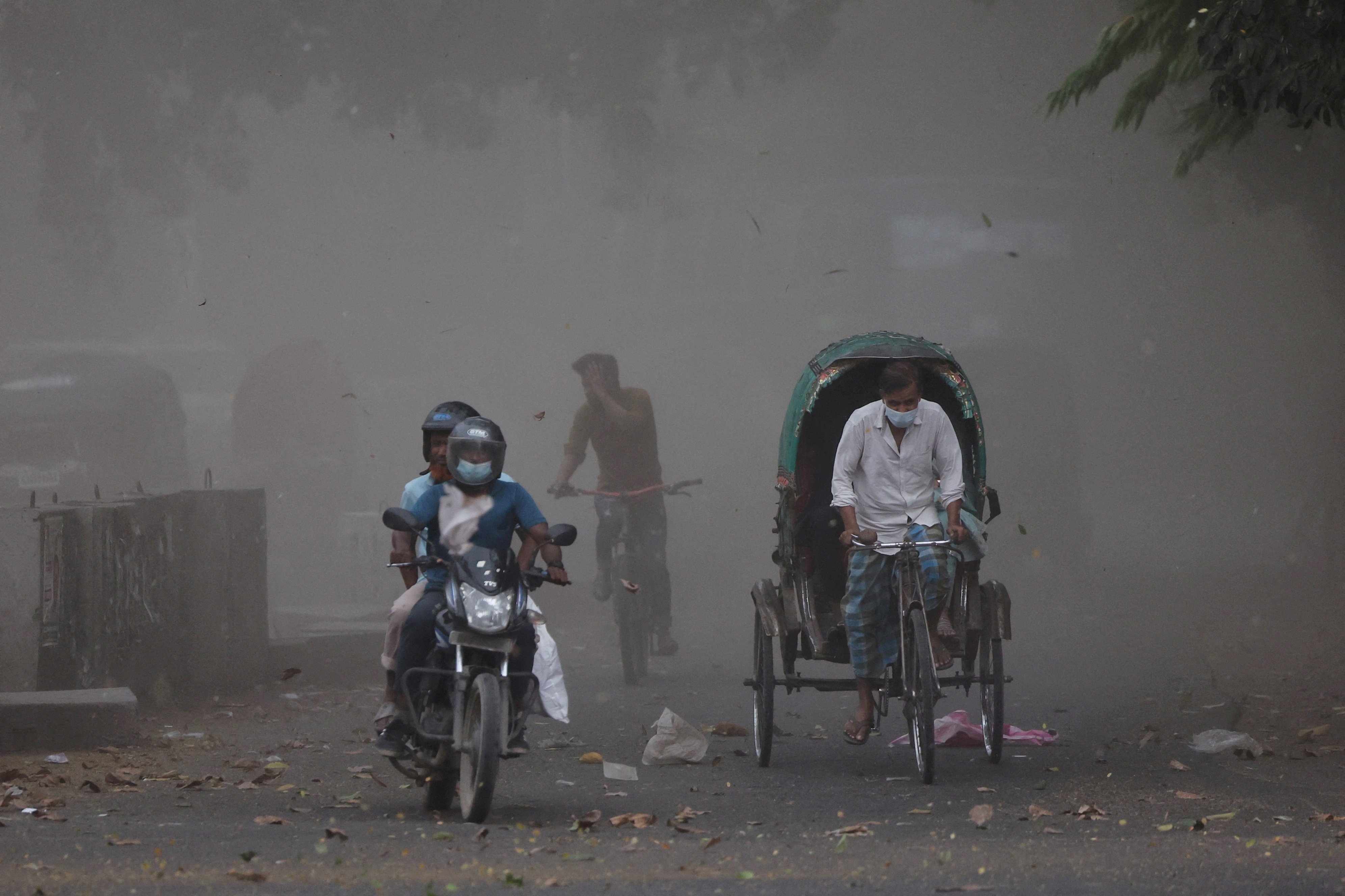A gust of wind blows dust and leaves into the air as a storm approaches after a heat wave in Dhaka. Photo: Reuters