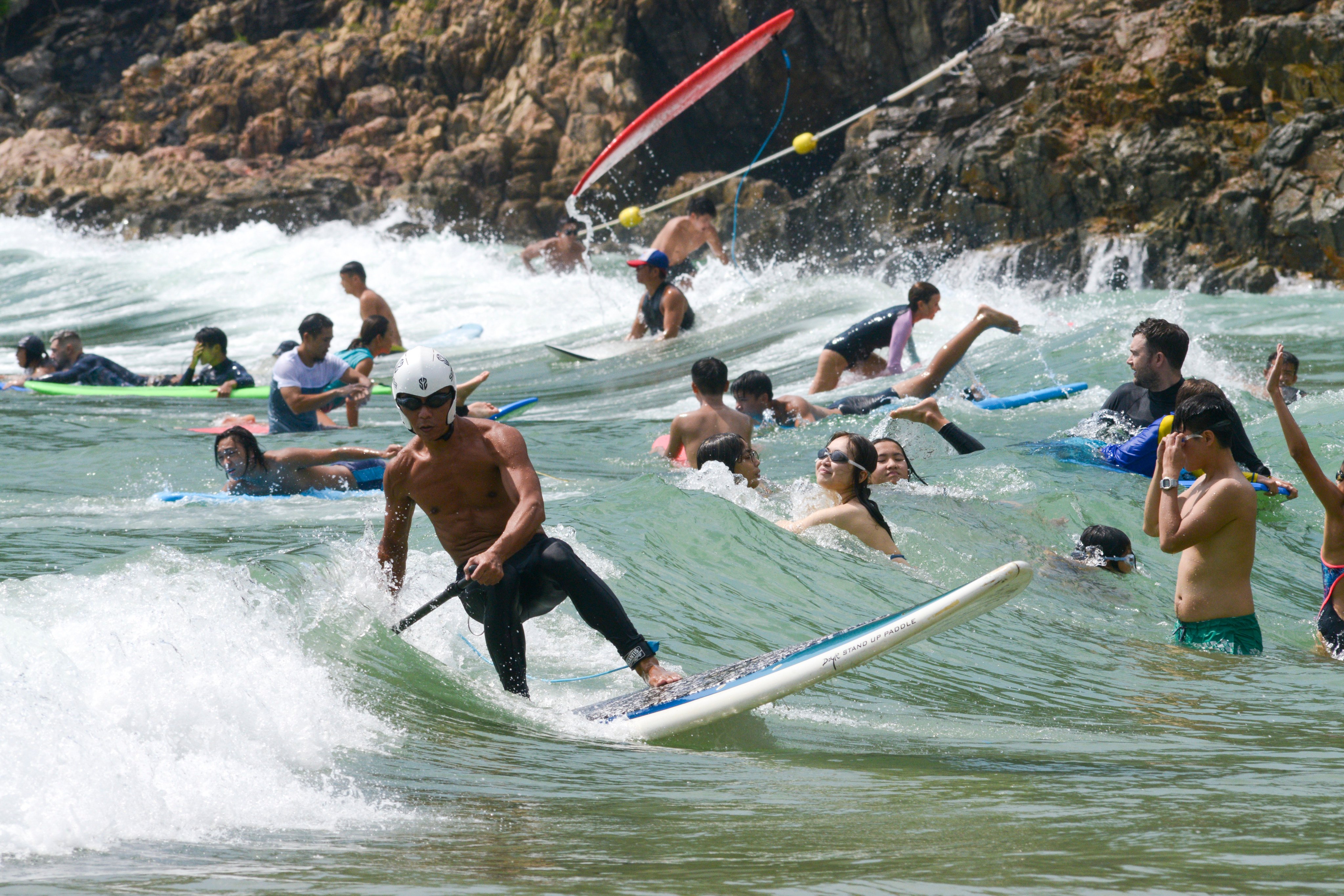 Beachgoers enjoy the sun and surf at Hong Kong’s Big Wave Bay. Photo: Antony Dickson