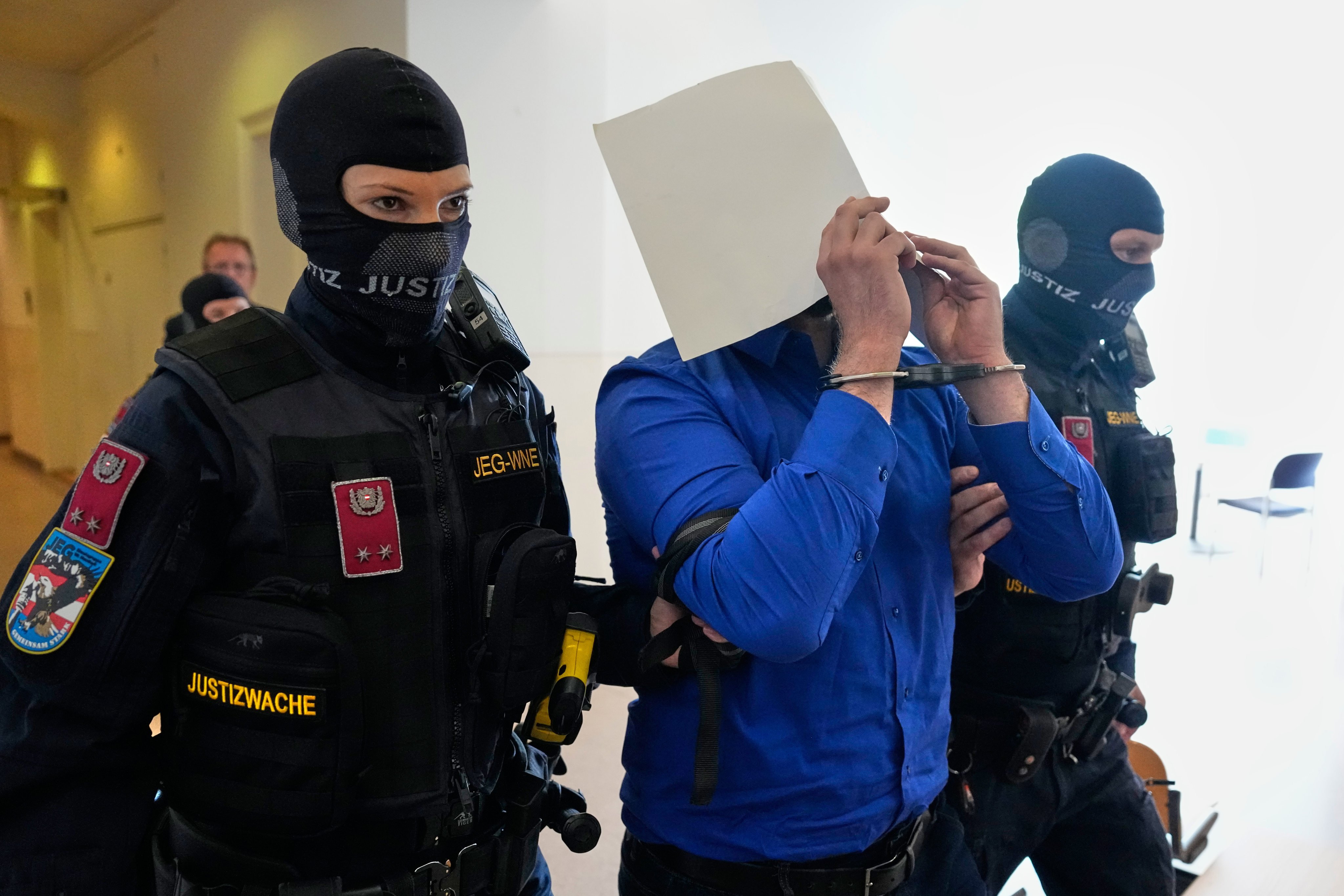 Defendant Beran A hides his face while being escorted out of court in Austria. He is standing trial for plotting to carry out an attack on one of superstar singer Taylor Swift’s 2024 Vienna concerts. Photo: AP