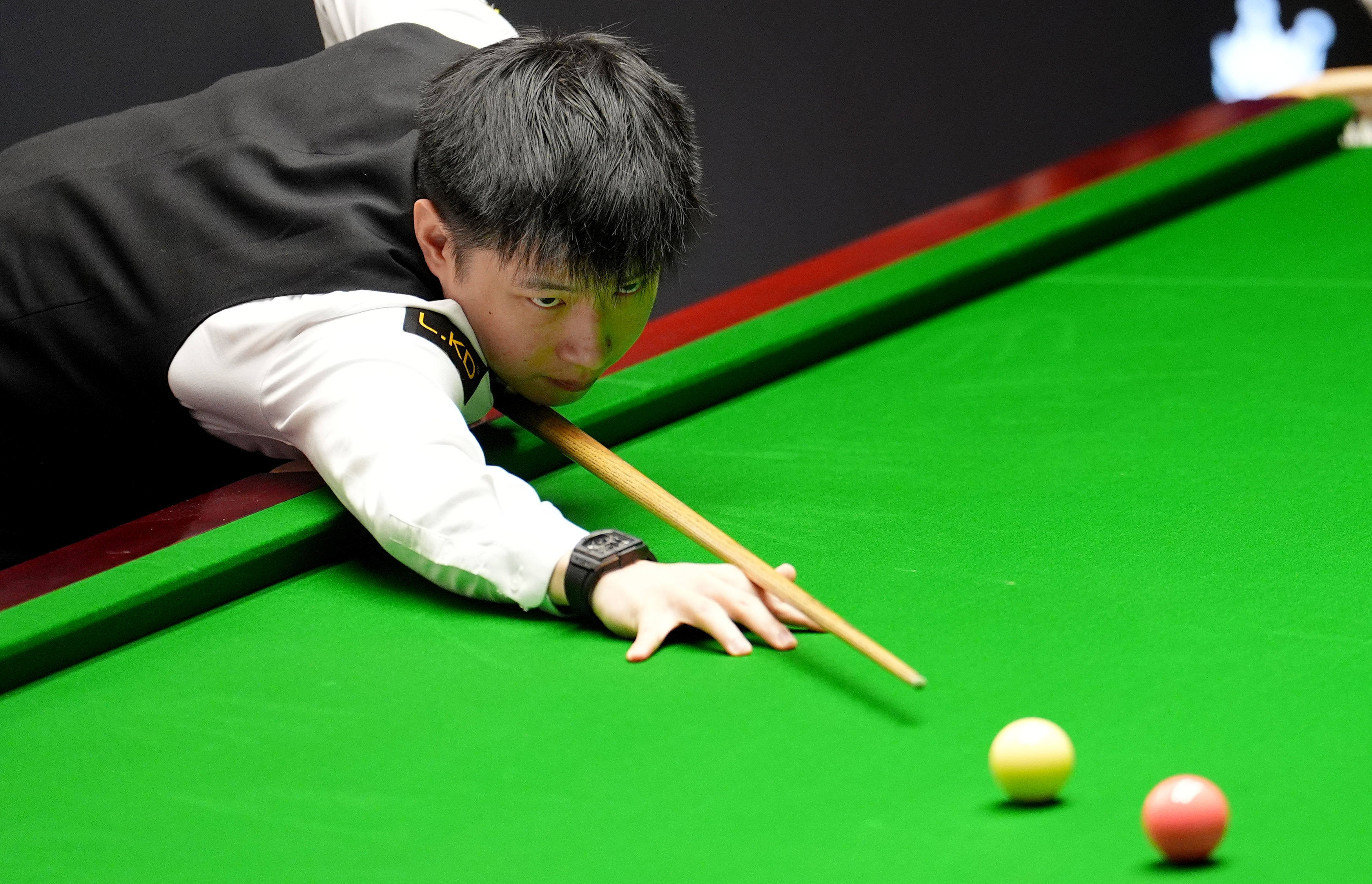 Zhao Xintong plays a shot against Shaun Murphy on day eleven of the World Snooker Championship in Sheffield, England on Tuesday. Photo: AP