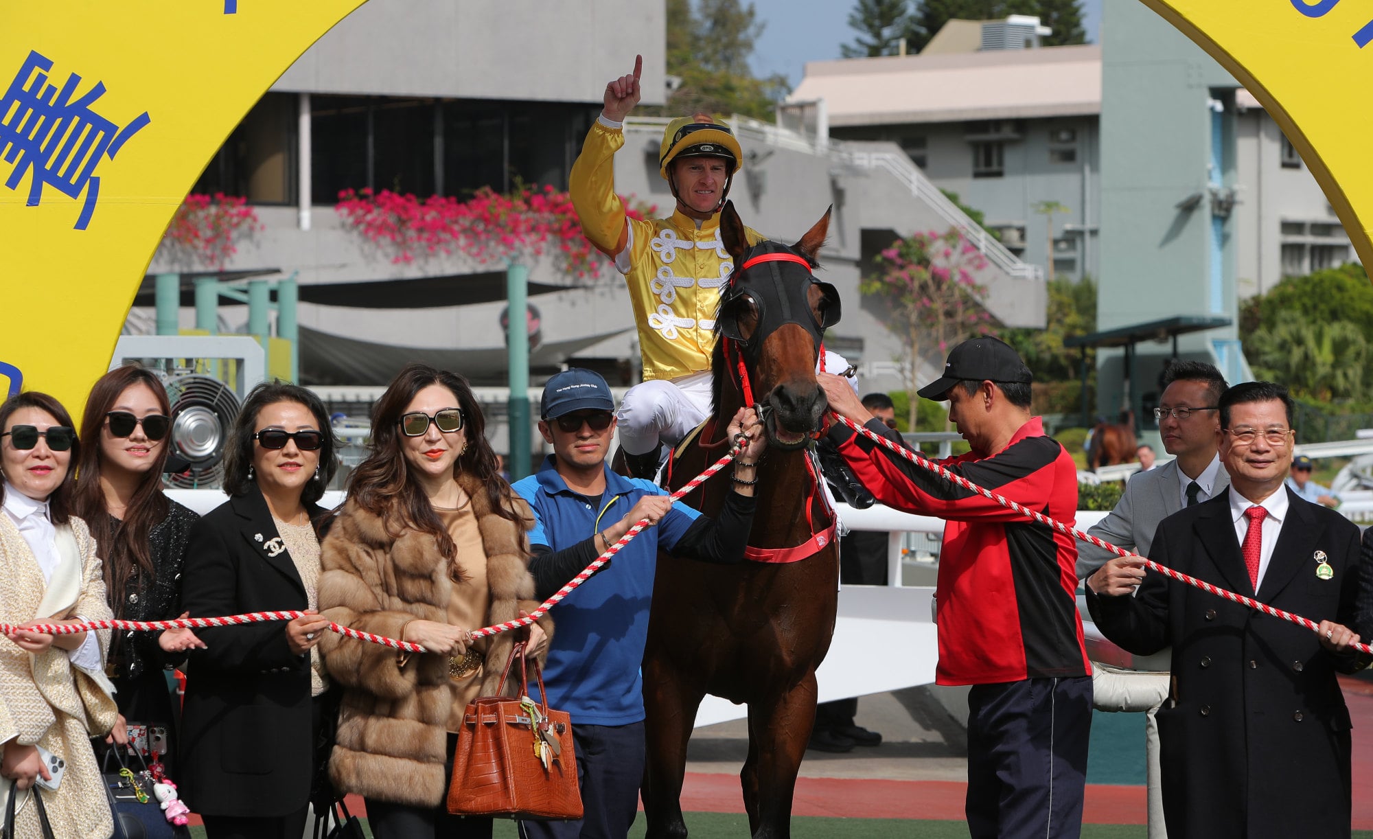 Connections celebrate the win of Crossborderdude at Sha Tin.