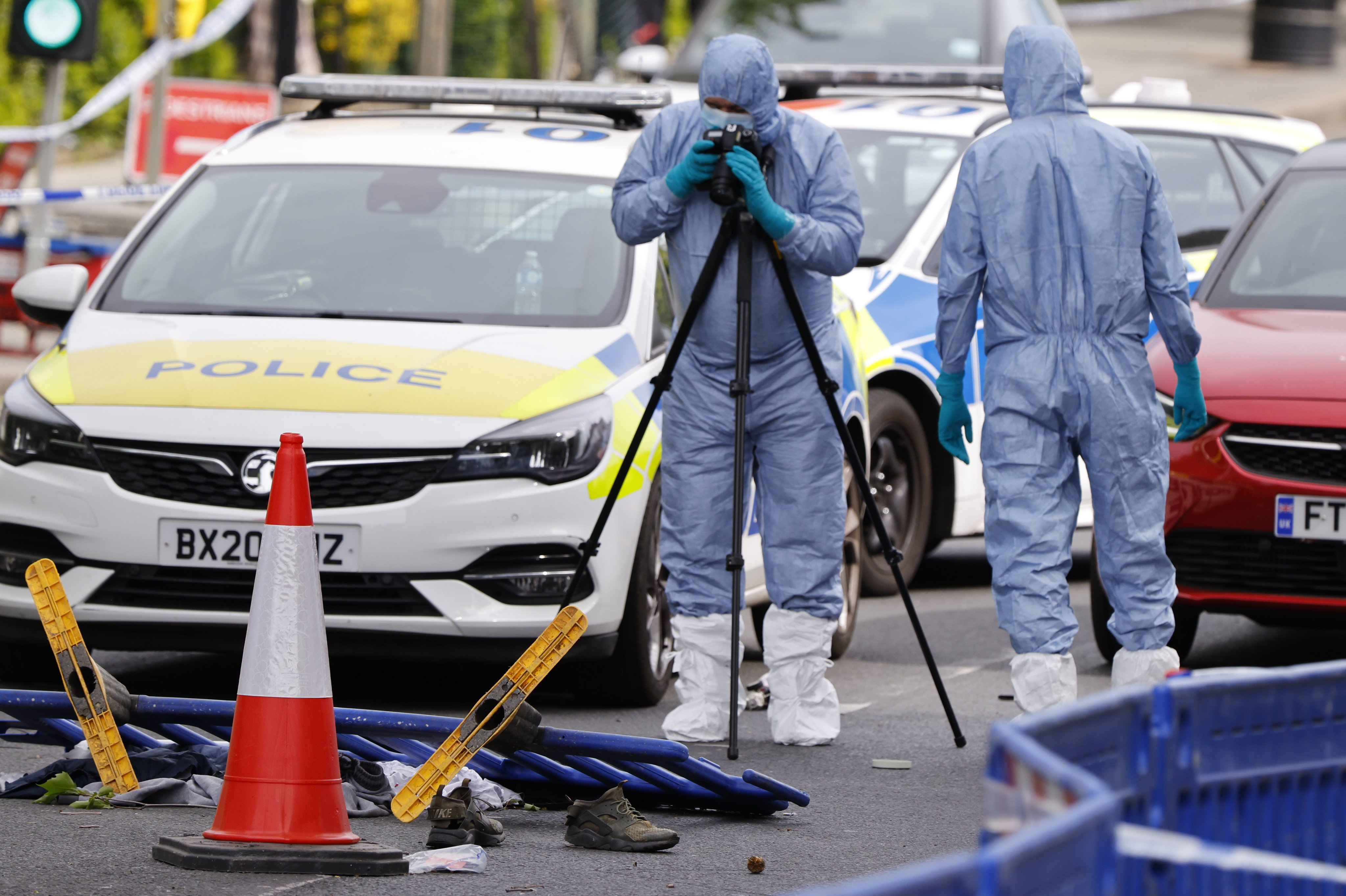 Forensic police officers inspect the scene where two Jewish men were stabbed in London on Wednesday. Photo: EPA