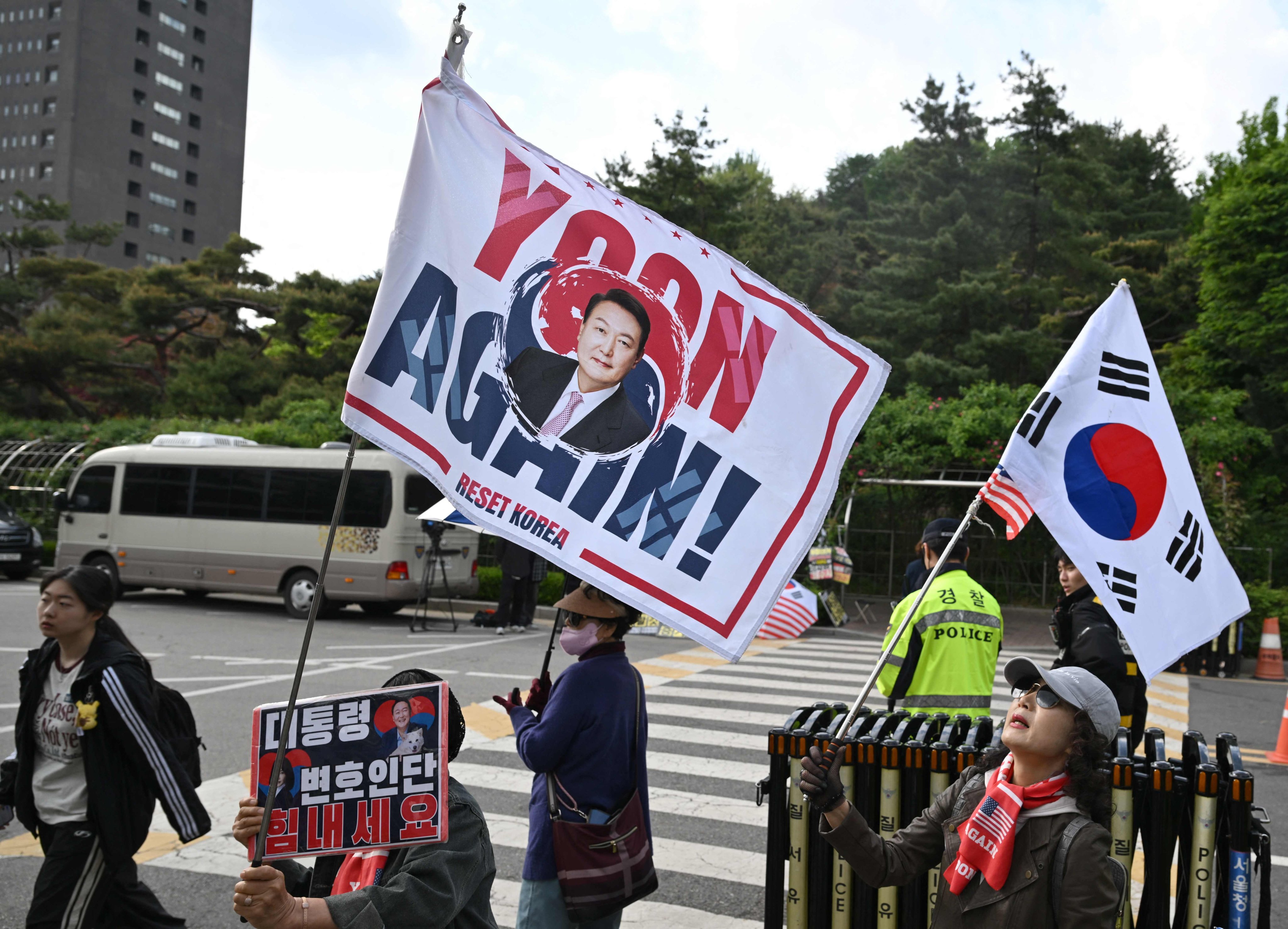 Supporters of South Korea’s former president Yoon Suk-yeol wave flags near the Seoul High Court in Seoul on Tuesday. Photo: AFP